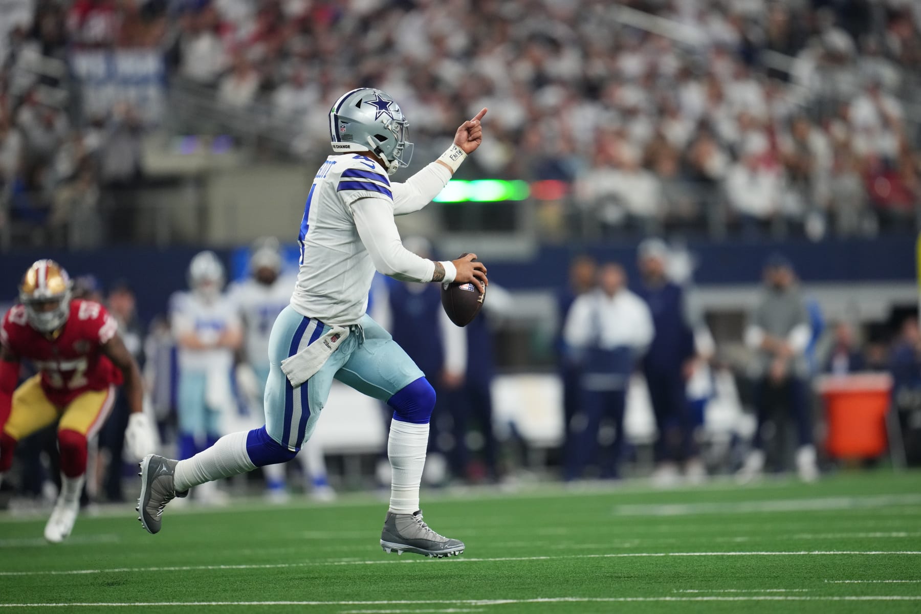 ARLINGTON, TEXAS - JANUARY 16: Dak Prescott #4 of the Dallas Cowboys scrambles with the ball against the San Francisco 49ers during an NFL wild-card playoff football game at AT&T Stadium on January 16, 2022 in Arlington, Texas.  (Photo by Cooper Neill/Getty Images)