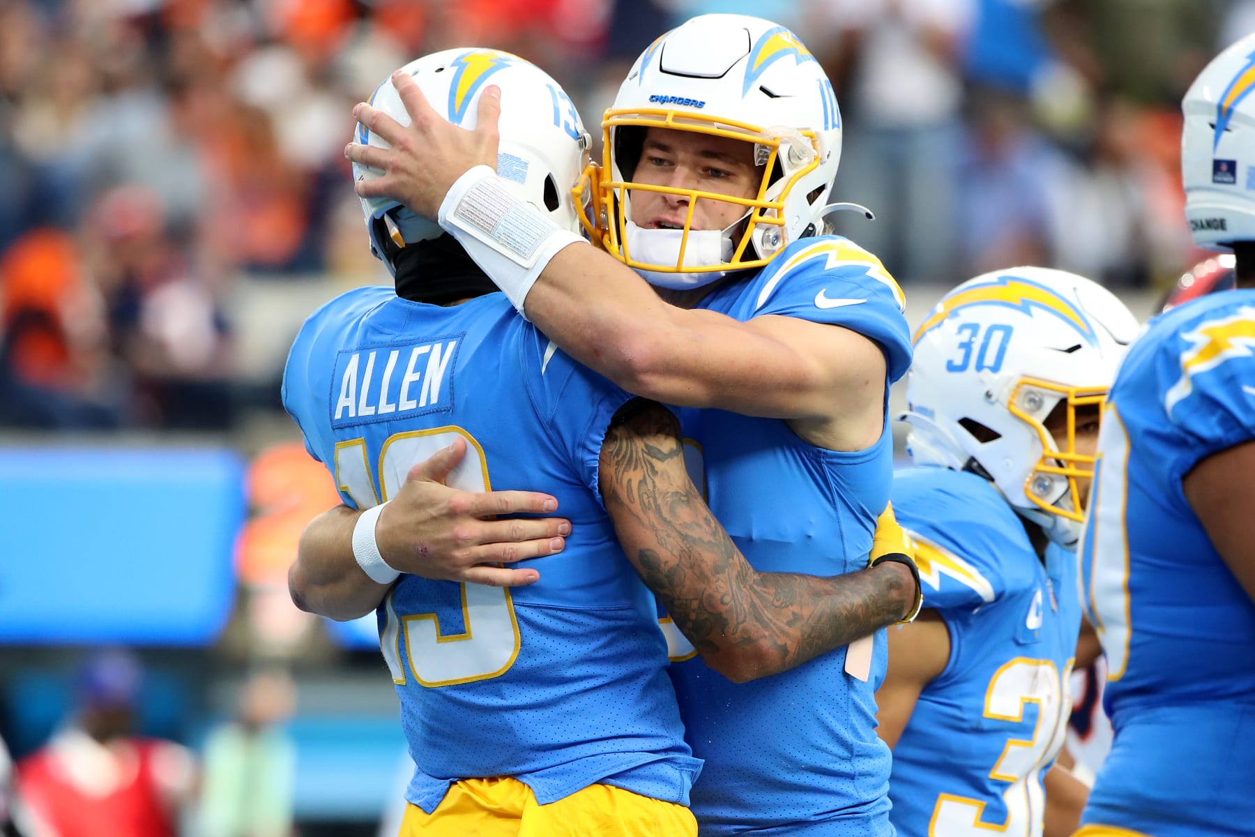 INGLEWOOD, CALIFORNIA - JANUARY 02: Keenan Allen #13 of the Los Angeles Chargers celebrates with Justin Herbert #10 after a touchdown over the Denver Broncos in the second quarter of the game at SoFi Stadium on January 02, 2022 in Inglewood, California. (Photo by Katelyn Mulcahy/Getty Images)