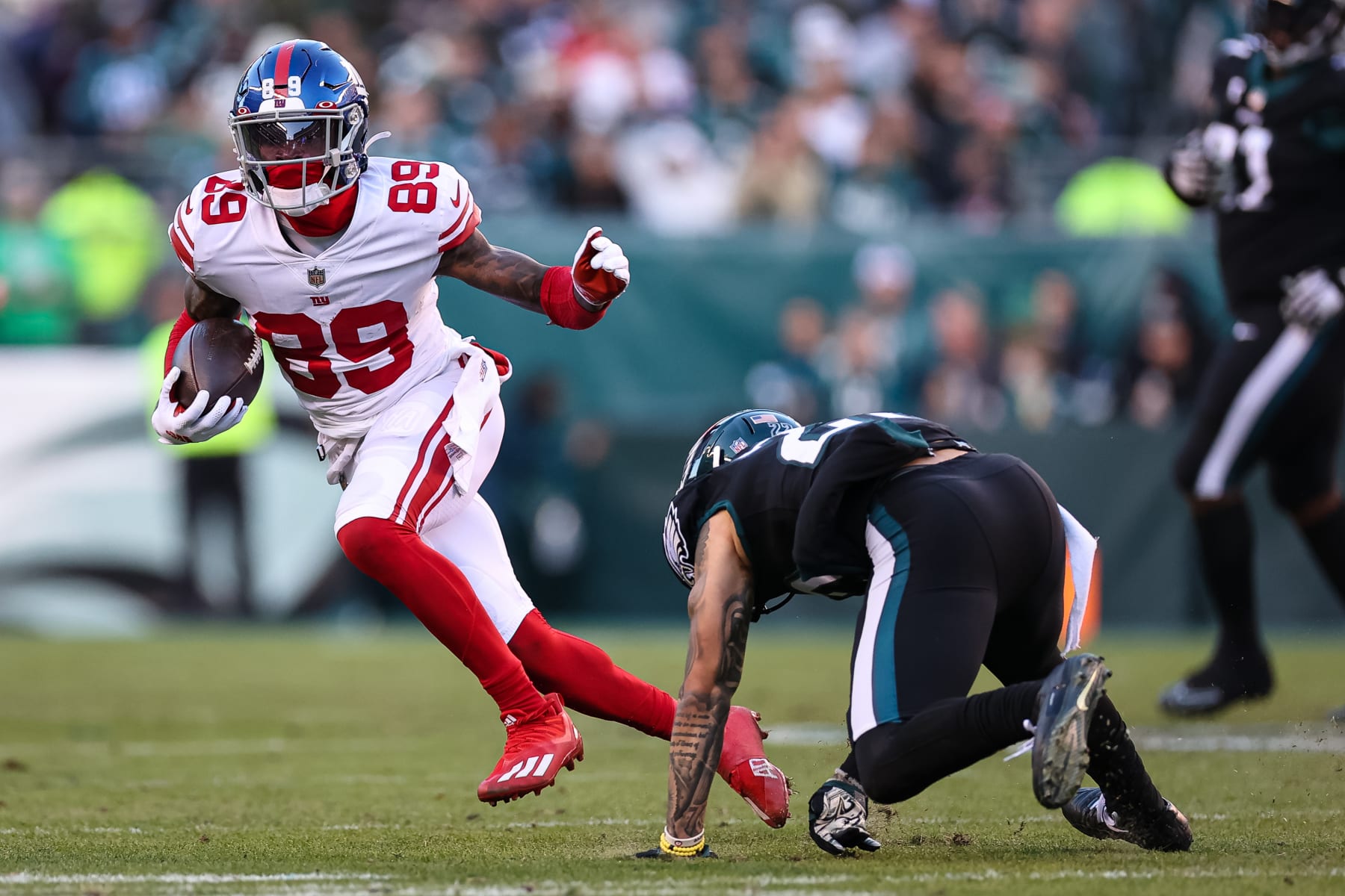 PHILADELPHIA, PA - DECEMBER 26: Kadarius Toney #89 of the New York Giants carries the ball against Marcus Epps #22 of the Philadelphia Eagles during the second half at Lincoln Financial Field on December 26, 2021 in Philadelphia, Pennsylvania. (Photo by Scott Taetsch/Getty Images) No licensing by any casino, sportsbook, and/or fantasy sports organization for any purpose. During game play, no use of images within play-by-play, statistical account or depiction of a game (e.g., limited to use of fewer than 10 images during the game).
