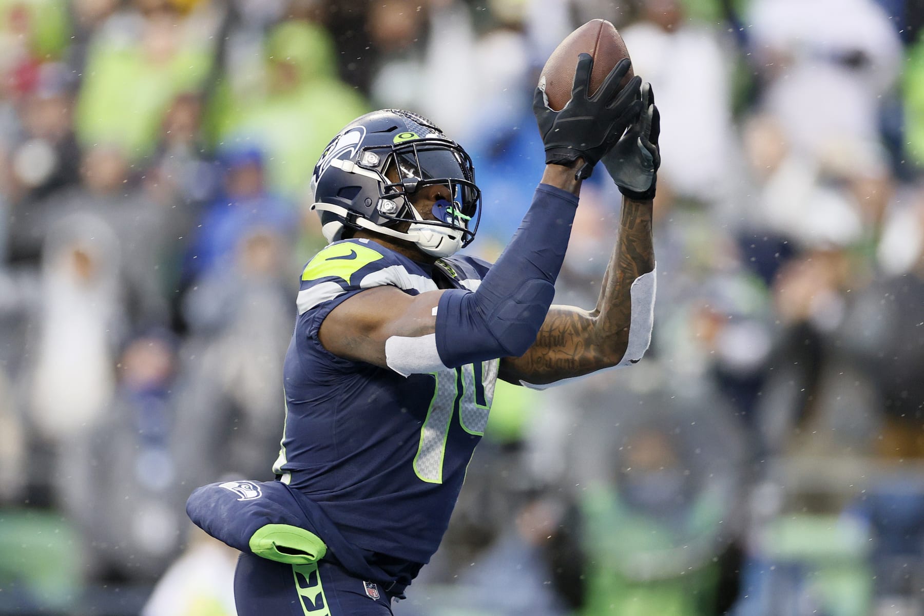 SEATTLE, WASHINGTON - JANUARY 02: DK Metcalf #14 of the Seattle Seahawks catches a pass for a touchdown against the Detroit Lions during the first half at Lumen Field on January 02, 2022 in Seattle, Washington. (Photo by Steph Chambers/Getty Images)