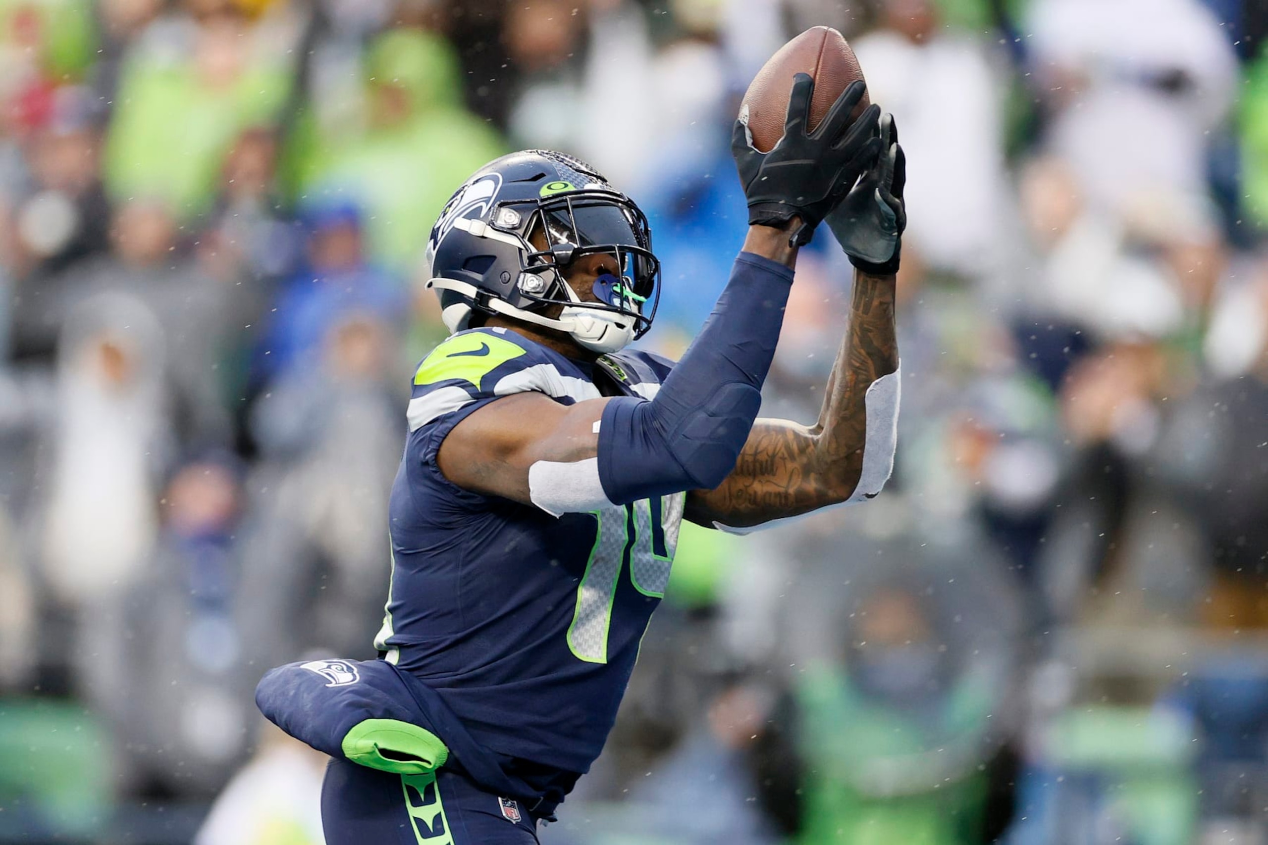 SEATTLE, WASHINGTON - JANUARY 02: DK Metcalf #14 of the Seattle Seahawks catches a pass for a touchdown against the Detroit Lions during the first half at Lumen Field on January 02, 2022 in Seattle, Washington. (Photo by Steph Chambers/Getty Images)