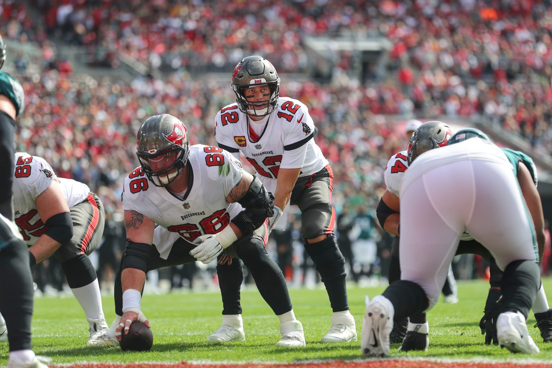 TAMPA, FL - JANUARY 16: Tampa Bay Buccaneers Quarterback Tom Brady (12) looks over the defense as he sets up for the snap of the football from Center Ryan Jensen (66) during the NFL Wild Card game between the Philadelphia Eagles and the Tampa Bay Buccaneers on January 16, 2022 at Raymond James Stadium in Tampa, Florida. (Photo by Cliff Welch/Icon Sportswire via Getty Images)