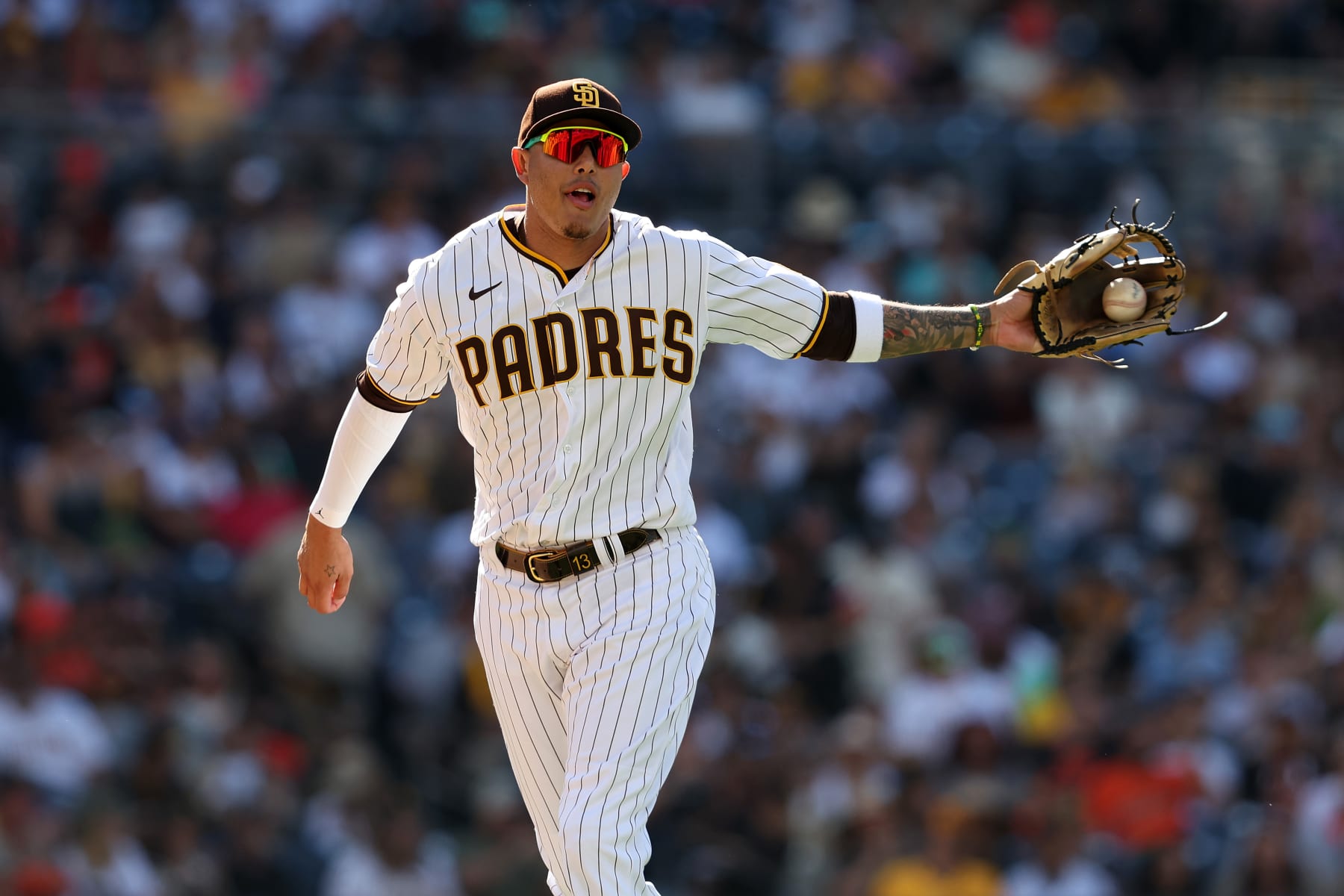 SAN DIEGO, CALIFORNIA - JULY 09: Manny Machado #13 of the San Diego Padres returns to the dugout during the third inning of a game against the San Francisco Giants at PETCO Park on July 09, 2022 in San Diego, California. (Photo by Sean M. Haffey/Getty Images)