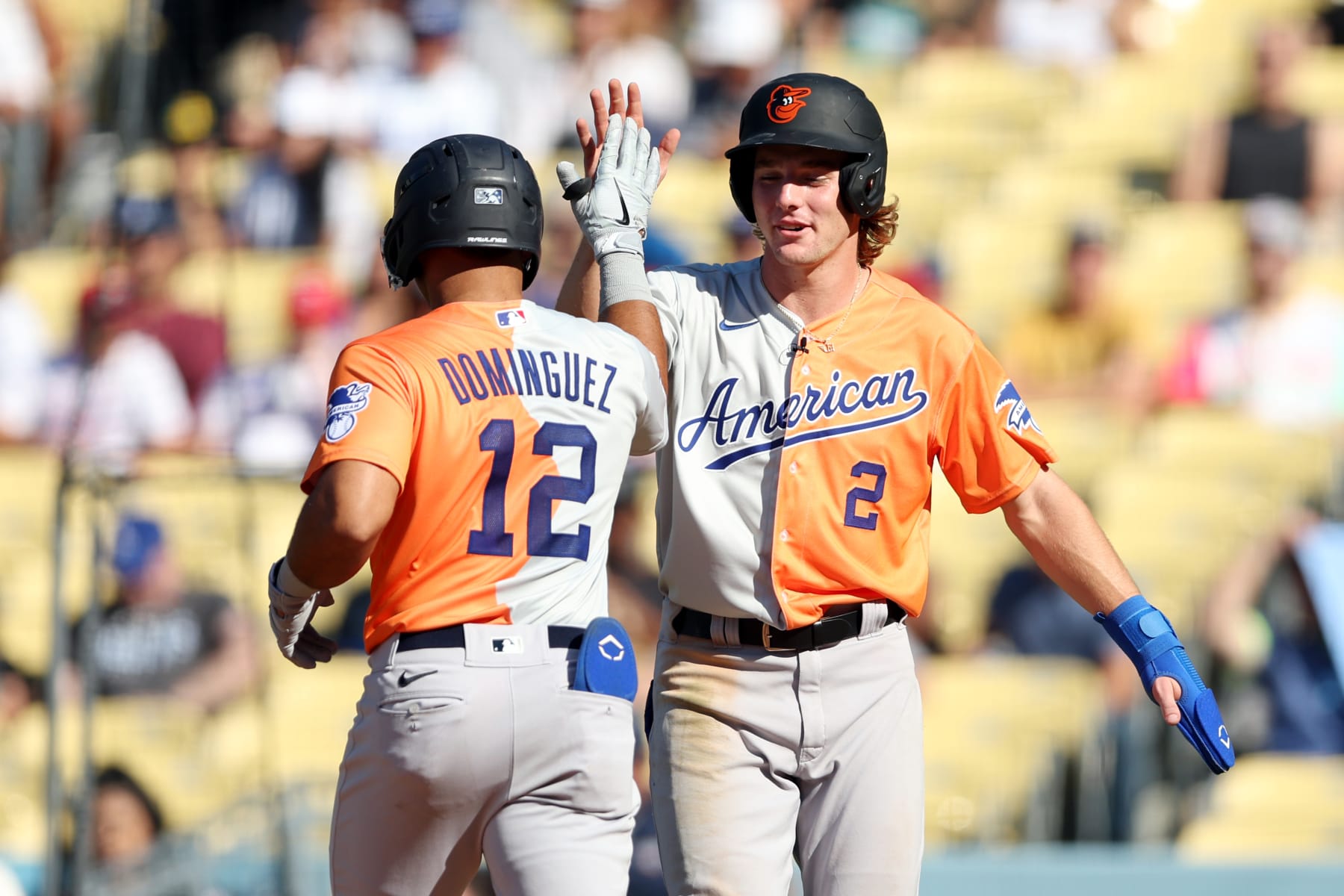 LOS ANGELES, CA - JULY 16:  Jasson Dominguez #12 of the New York Yankees is greeted by teammate Gunnar Henderson #2 of the Baltimore Orioles after hitting a two-run home run in the third inning during the 2022 SiriusXM All-Star Futures Game at Dodger Stadium on Saturday, July 16, 2022 in Los Angeles, California. (Photo by Rob Tringali/MLB Photos via Getty Images)