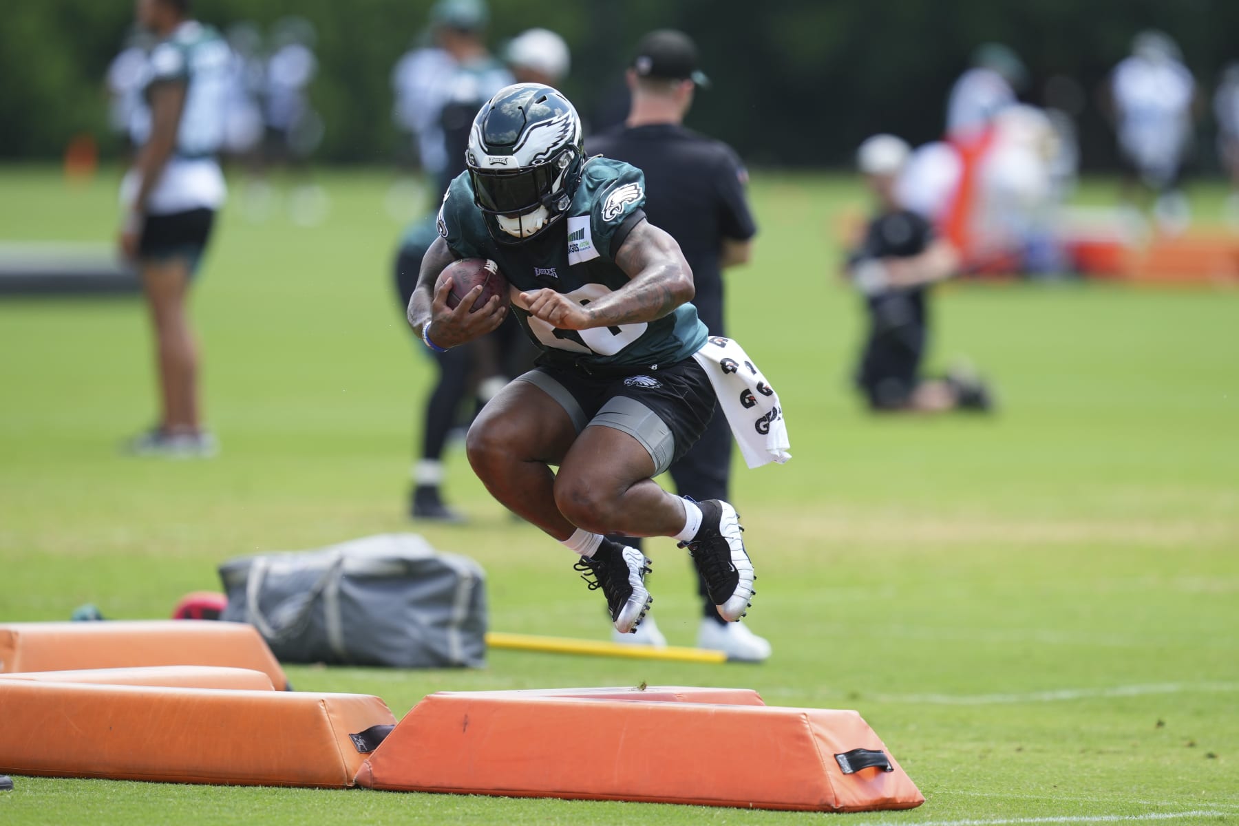 PHILADELPHIA, PA - JUNE 08: Miles Sanders #26 of the Philadelphia Eagles jumps over a pad during OTAs at the NovaCare Complex on June 8, 2022 in Philadelphia, Pennsylvania. (Photo by Mitchell Leff/Getty Images)