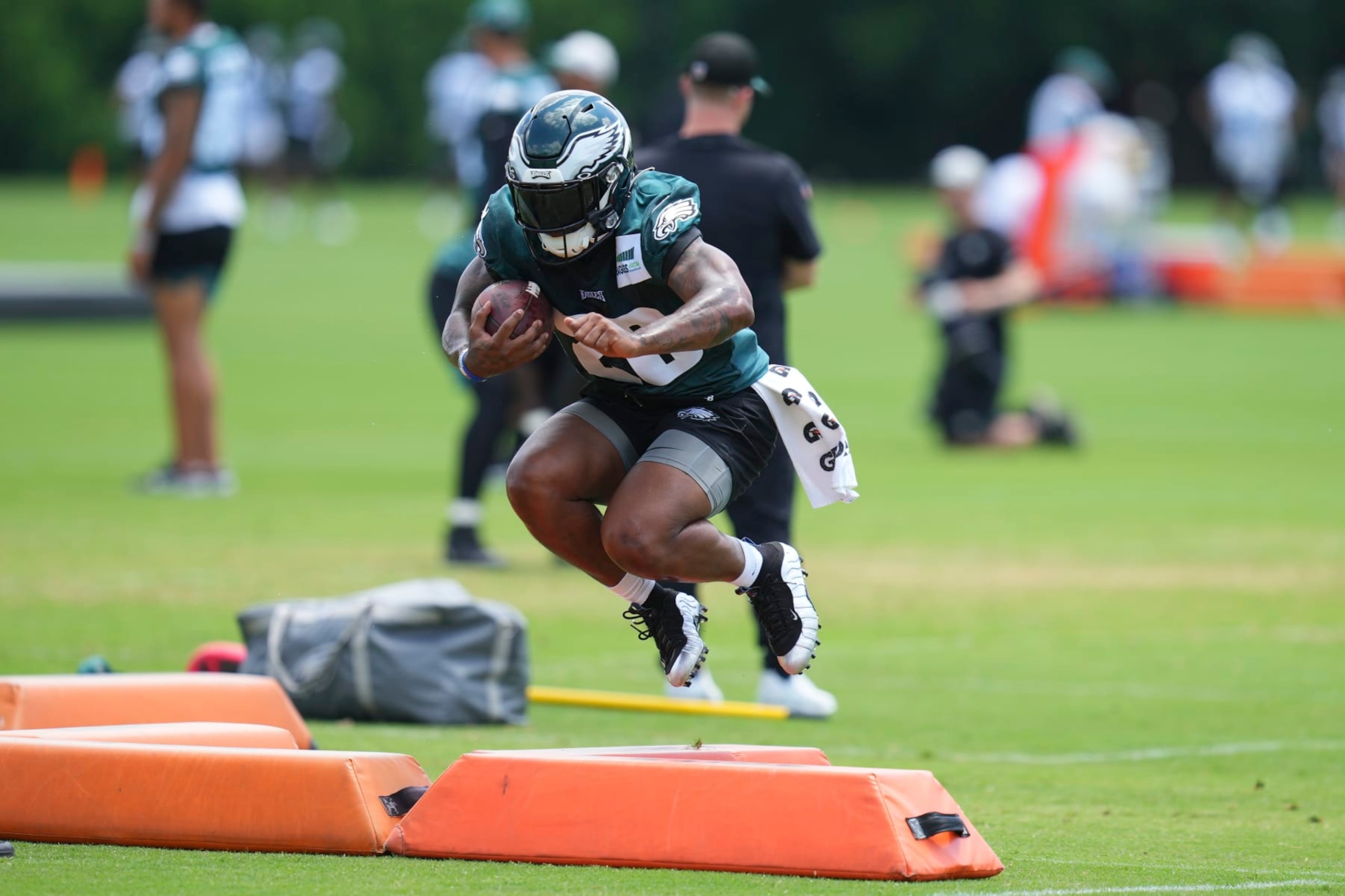 PHILADELPHIA, PA - JUNE 08: Miles Sanders #26 of the Philadelphia Eagles jumps over a pad during OTAs at the NovaCare Complex on June 8, 2022 in Philadelphia, Pennsylvania. (Photo by Mitchell Leff/Getty Images)