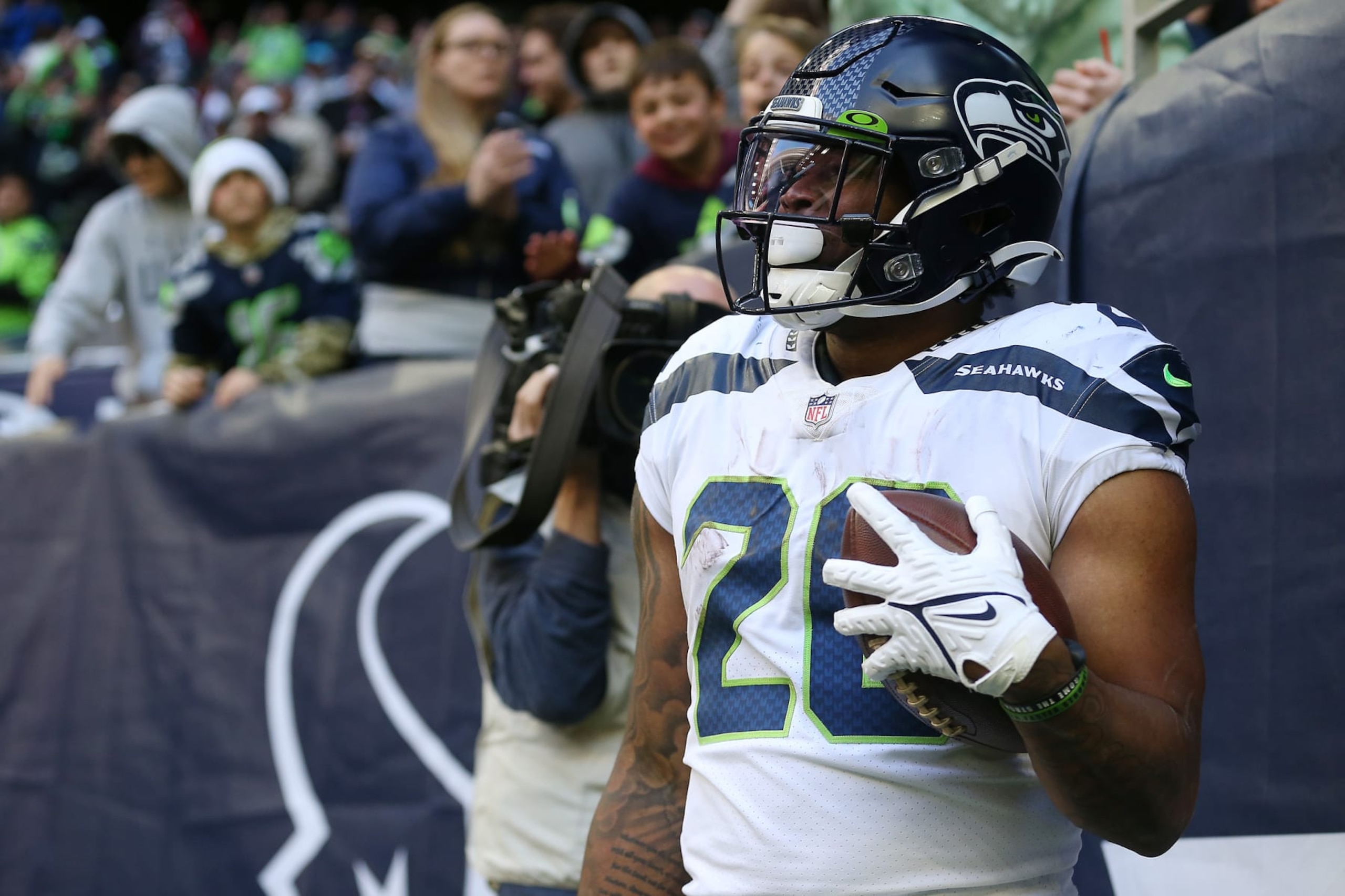 HOUSTON, TEXAS - DECEMBER 12: Rashaad Penny #20 of the Seattle Seahawks reacts after scoring a touchdown during the fourth quarter against the Houston Texans at NRG Stadium on December 12, 2021 in Houston, Texas. (Photo by Tim Warner/Getty Images)