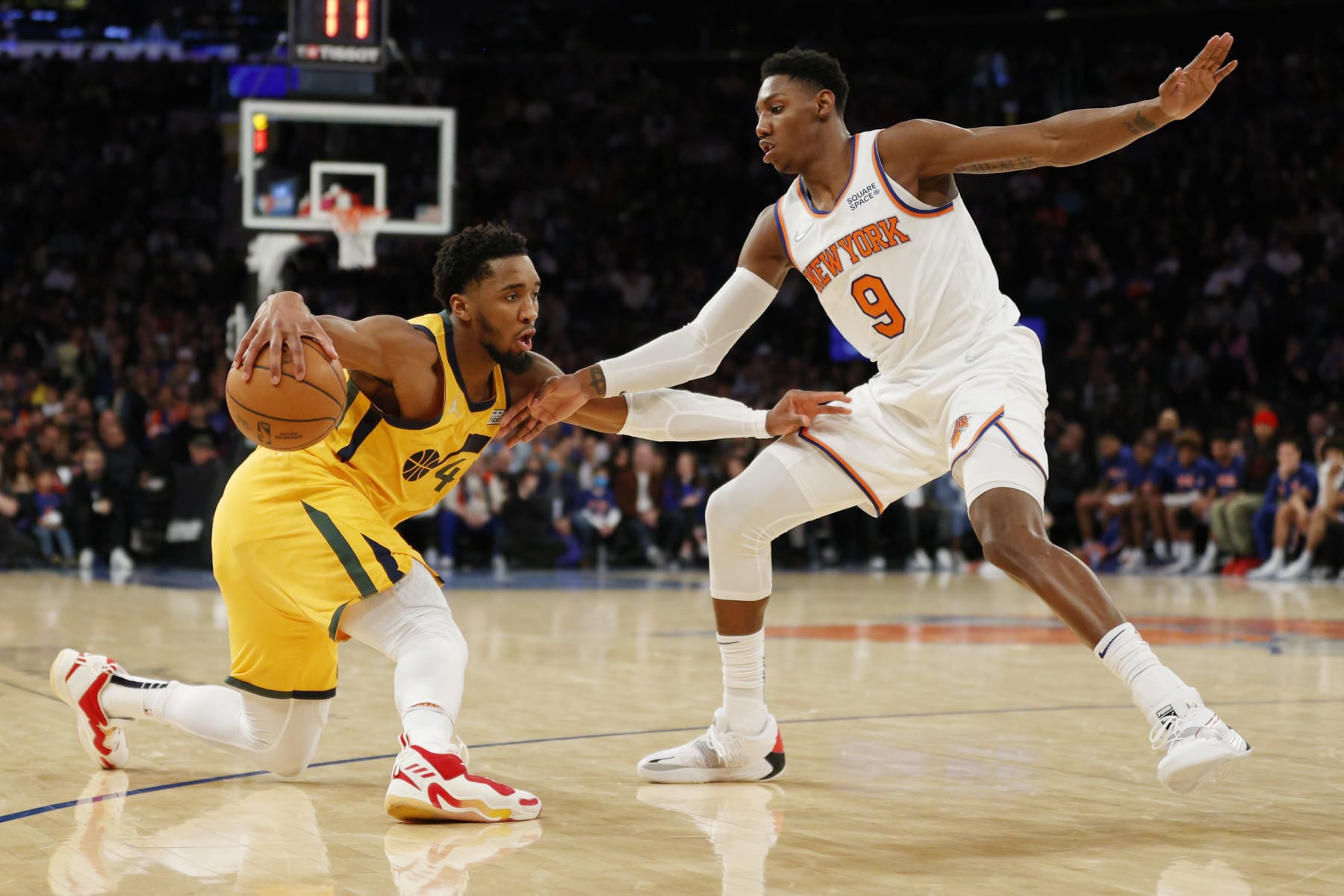 NEW YORK, NEW YORK - MARCH 20: Donovan Mitchell #45 of the Utah Jazz dribbles against RJ Barrett #9 of the New York Knicks during the second half at Madison Square Garden on March 20, 2022 in New York City. The Jazz won 108-93. NOTE TO USER: User expressly acknowledges and agrees that, by downloading and or using this photograph, User is consenting to the terms and conditions of the Getty Images License Agreement. (Photo by Sarah Stier/Getty Images)