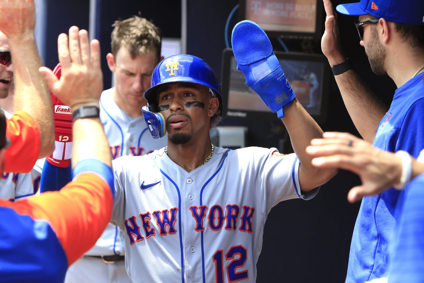ATLANTA, GA - JULY 13: Francisco Lindor (12) of the New York Mets is congratulated by his teammates after scoring  during the MLB game between the New York Mets and the Atlanta Braves on July 13, 2022 at Truist Park in Atlanta, GA. (Photo by Jeff Robinson/Icon Sportswire via Getty Images)