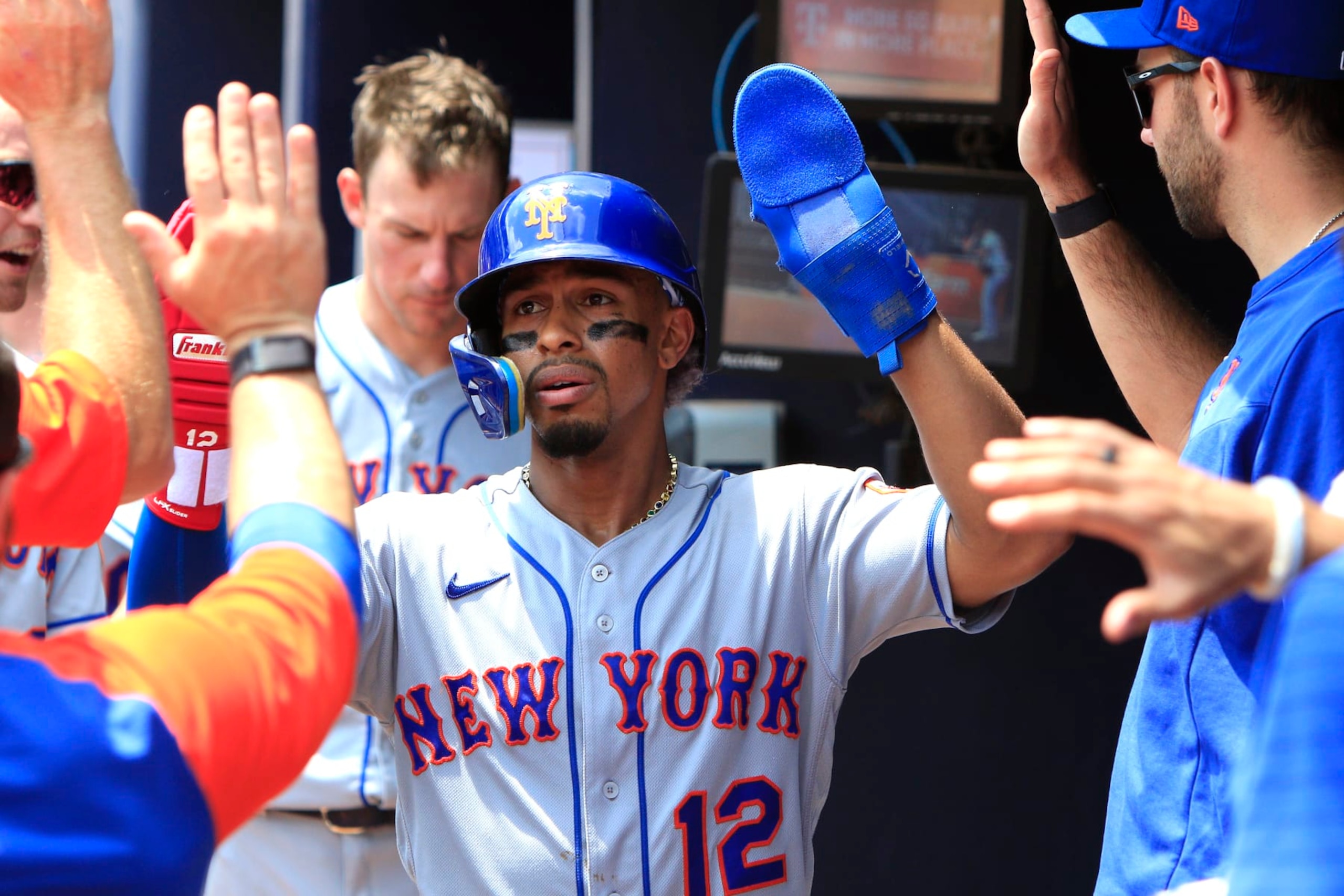 ATLANTA, GA - JULY 13: Francisco Lindor (12) of the New York Mets is congratulated by his teammates after scoring  during the MLB game between the New York Mets and the Atlanta Braves on July 13, 2022 at Truist Park in Atlanta, GA. (Photo by Jeff Robinson/Icon Sportswire via Getty Images)
