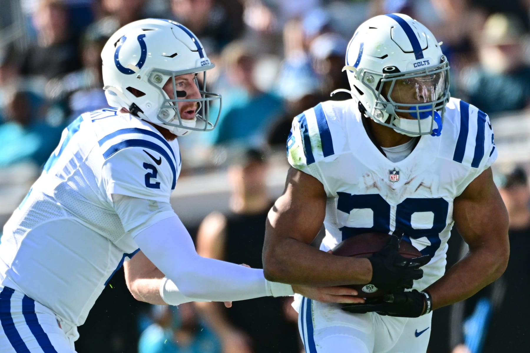 JACKSONVILLE, FLORIDA - JANUARY 09: Carson Wentz #2 of the Indianapolis Colts hands the ball off to Jonathan Taylor #28 of the Indianapolis Colts during the second quarter in the game against the Jacksonville Jaguars at TIAA Bank Field on January 09, 2022 in Jacksonville, Florida. (Photo by Julio Aguilar/Getty Images)