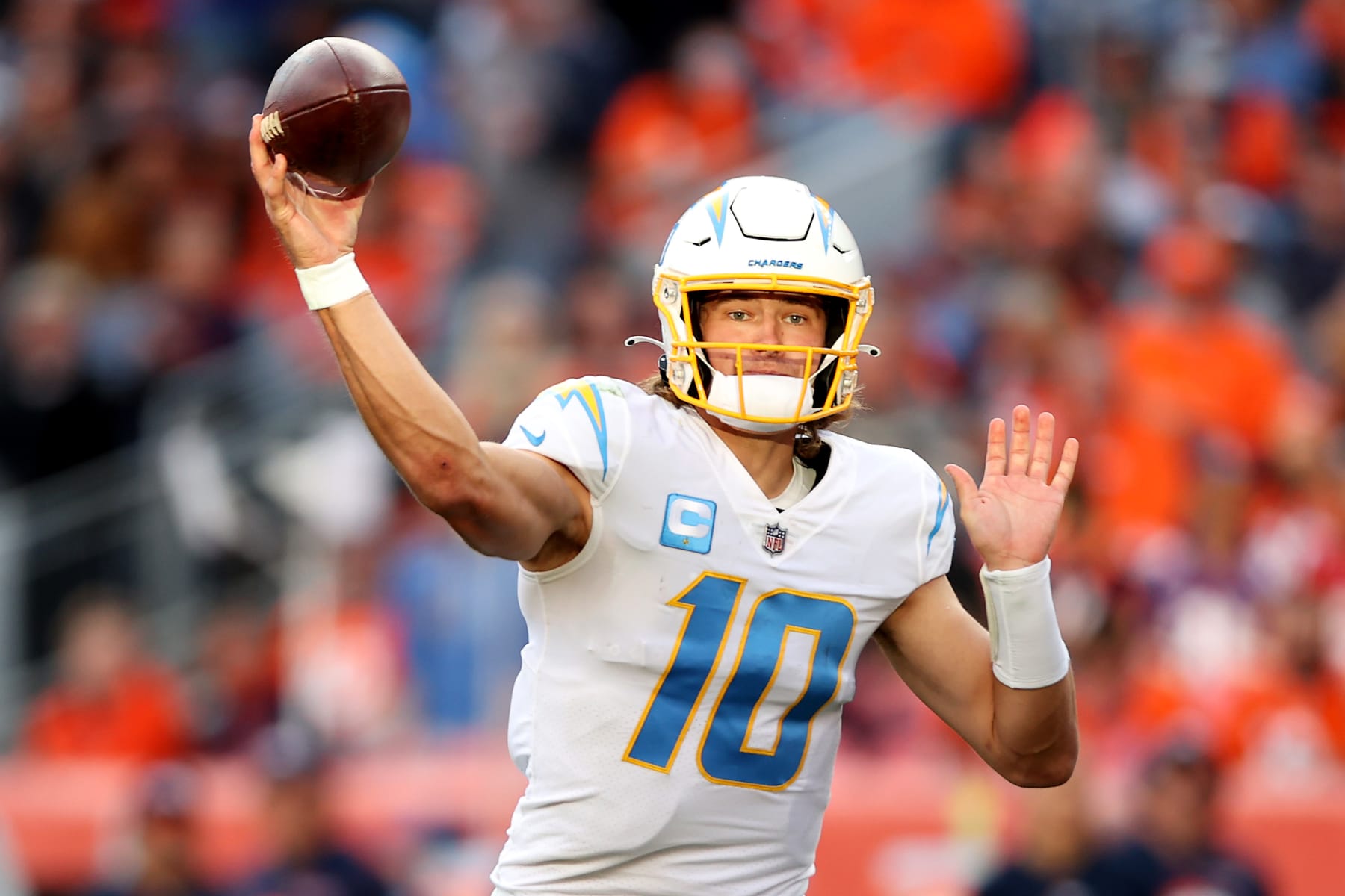 DENVER, COLORADO - NOVEMBER 28: Justin Herbert #10 of the Los Angeles Chargers throws the ball in the first half of the game against the Denver Broncos at Empower Field At Mile High on November 28, 2021 in Denver, Colorado. (Photo by Matthew Stockman/Getty Images)
