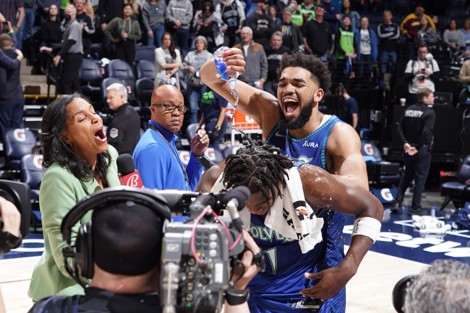 MINNEAPOLIS, MN -  APRIL 7: Karl-Anthony Towns #32 of the Minnesota Timberwolves pours water on Anthony Edwards #1 of the Minnesota Timberwolves after the game against the San Antonio Spurs on April 7, 2022 at Target Center in Minneapolis, Minnesota. NOTE TO USER: User expressly acknowledges and agrees that, by downloading and or using this Photograph, user is consenting to the terms and conditions of the Getty Images License Agreement. Mandatory Copyright Notice: Copyright 2022 NBAE (Photo by Jordan Johnson/NBAE via Getty Images)