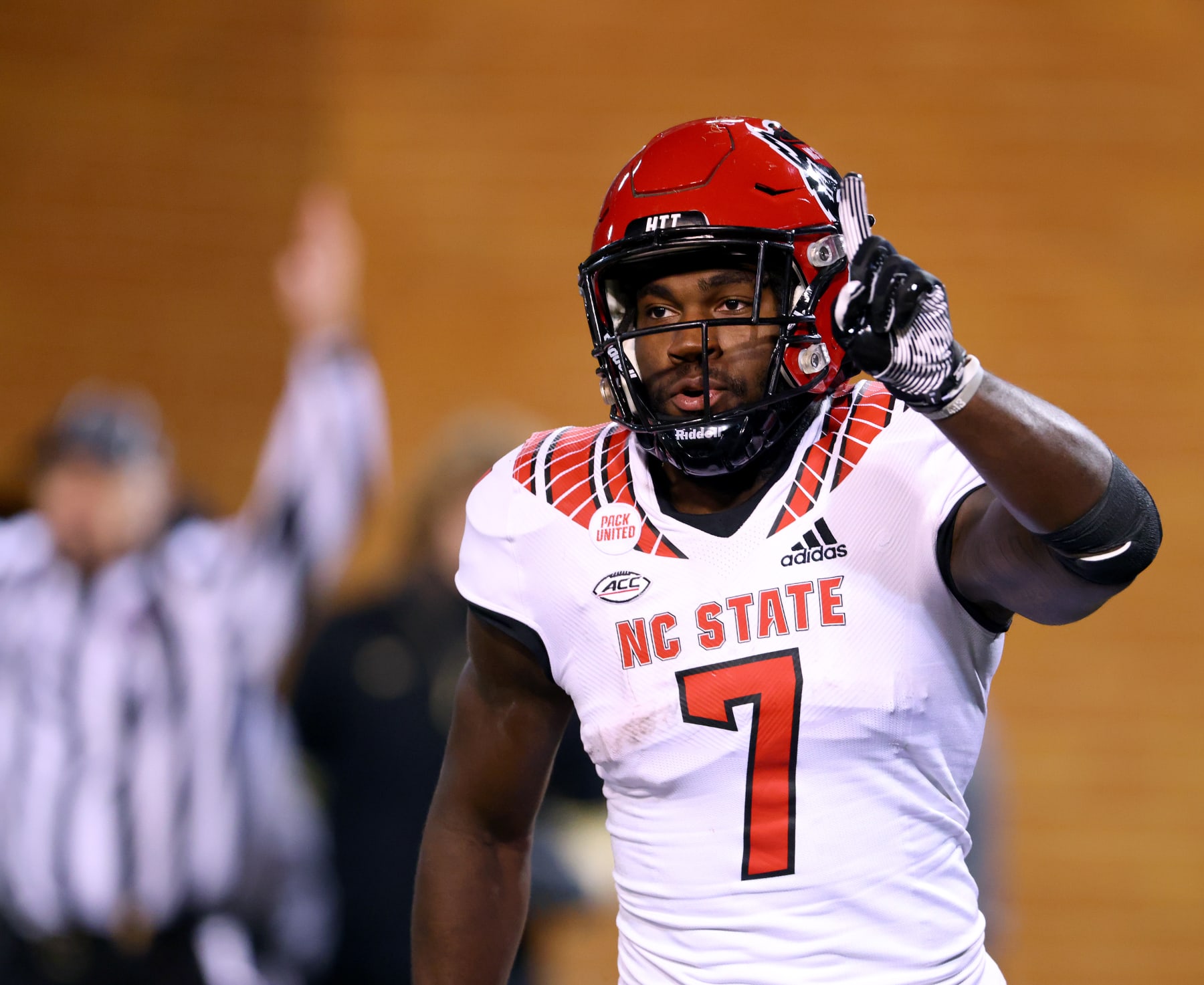 WINSTON-SALEM, NORTH CAROLINA - NOVEMBER 13: Zonovan Knight #7 of the North Carolina State Wolfpack reacts after returning the opening kickoff of the second half for a touchdown against the Wake Forest Demon Deacons at Truist Field on November 13, 2021 in Winston-Salem, North Carolina. Wake Forest won 45-42. (Photo by Grant Halverson/Getty Images)