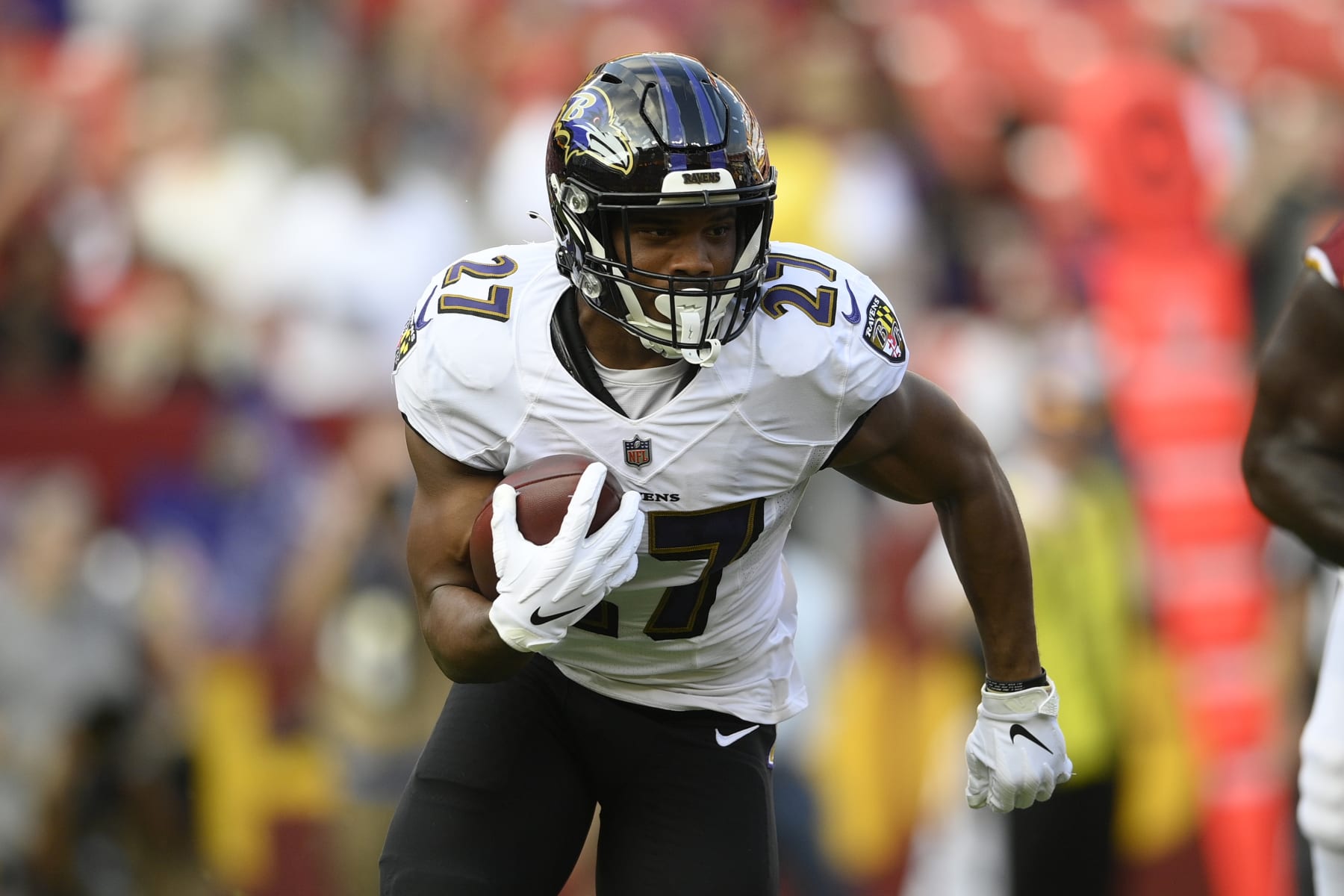 Baltimore Ravens running back J.K. Dobbins (27) runs with the ball during the first half of a preseason NFL football game against the Washington Football Team, Saturday, Aug. 28, 2021, in Landover, Md. (AP Photo/Nick Wass)