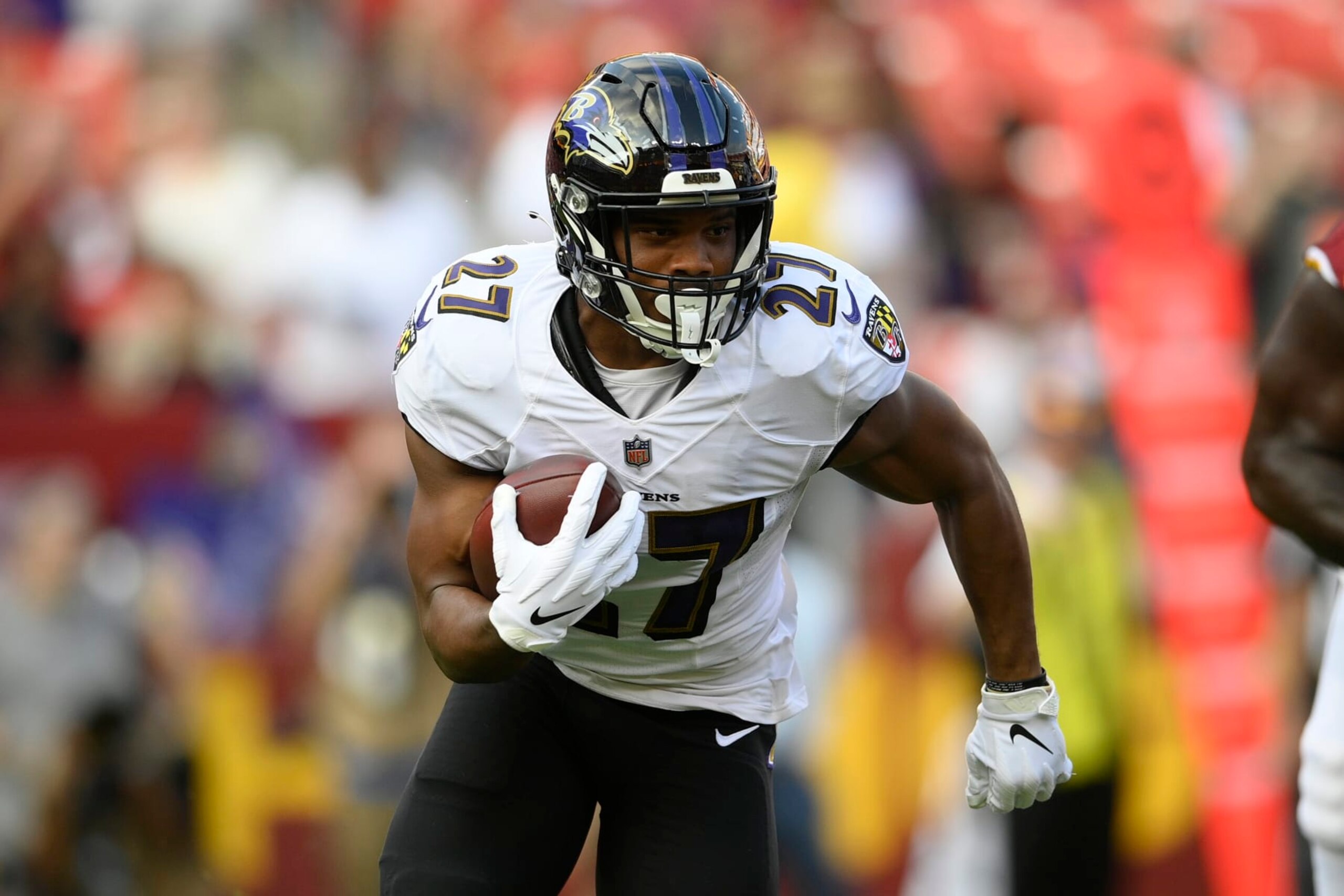 Baltimore Ravens running back J.K. Dobbins (27) runs with the ball during the first half of a preseason NFL football game against the Washington Football Team, Saturday, Aug. 28, 2021, in Landover, Md. (AP Photo/Nick Wass) Baltimore Ravens running back J.K. Dobbins (27) runs with the ball during the first half of a preseason NFL football game against the Washington Football Team, Saturday, Aug. 28, 2021, in Landover, Md. (AP Photo/Nick Wass)