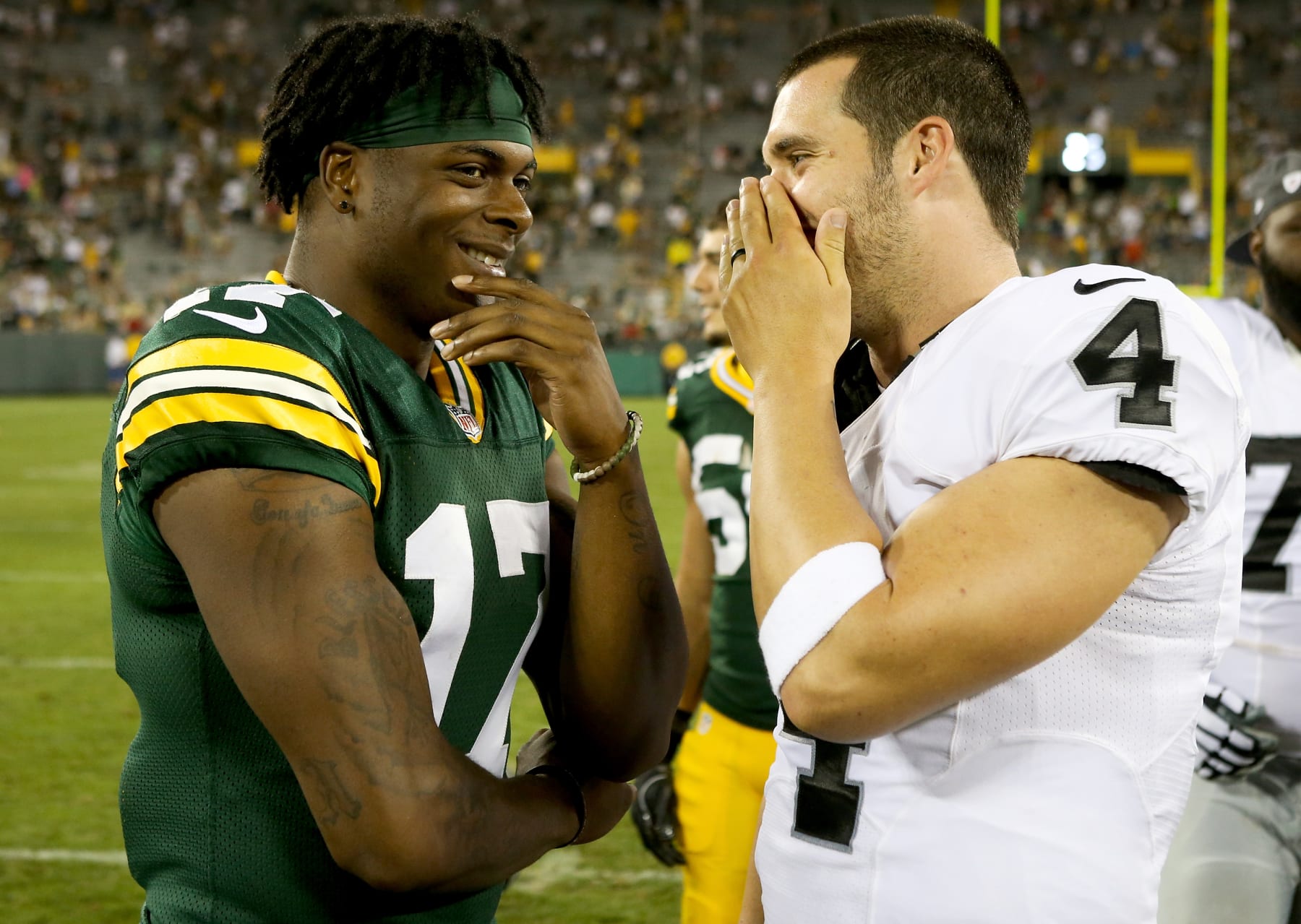 GREEN BAY, WI - AUGUST 18:  Davante Adams #17 of the Green Bay Packers and Derek Carr #4 of the Oakland Raiders chat after the preseason game at Lambeau Field on August 18, 2016 in Green Bay, Wisconsin. (Photo by Dylan Buell/Getty Images)