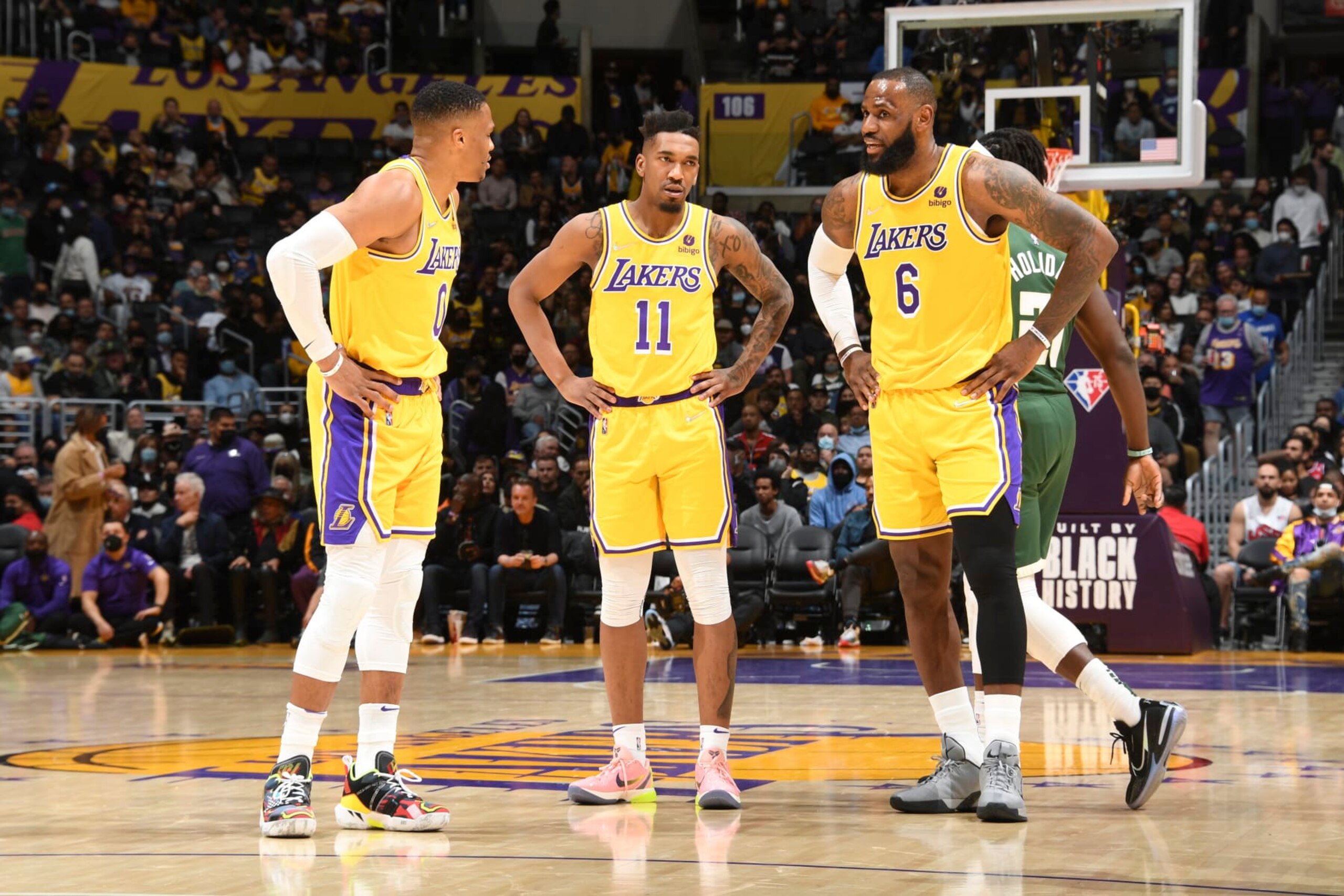 LOS ANGELES, CA - FEBRUARY 8: Malik Monk #11 of the Los Angeles Lakers talks to Russell Westbrook #0 of the Los Angeles Lakers and LeBron James #6 of the Los Angeles Lakers during the game against the Milwaukee Bucks on February 8, 2022 at Crypto.Com Arena in Los Angeles, California. NOTE TO USER: User expressly acknowledges and agrees that, by downloading and/or using this Photograph, user is consenting to the terms and conditions of the Getty Images License Agreement. Mandatory Copyright Notice: Copyright 2022 NBAE (Photo by Andrew D. Bernstein/NBAE via Getty Images)