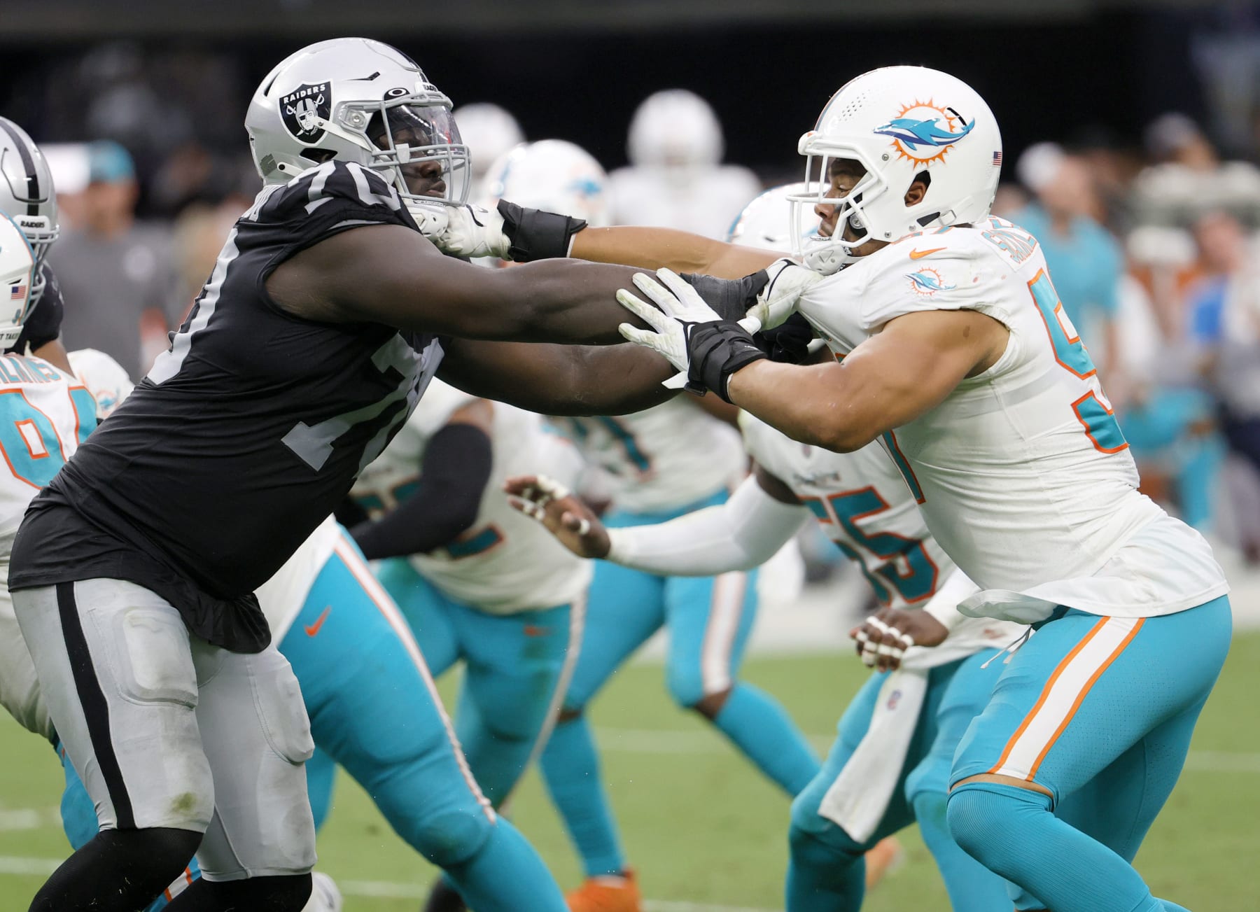 LAS VEGAS, NEVADA - SEPTEMBER 26:  Offensive tackle Alex Leatherwood #70 of the Las Vegas Raiders blocks outside linebacker Brennan Scarlett #57 of the Miami Dolphins during their game at Allegiant Stadium on September 26, 2021 in Las Vegas, Nevada. The Raiders defeated the Dolphins 31-28 in overtime.  (Photo by Ethan Miller/Getty Images)