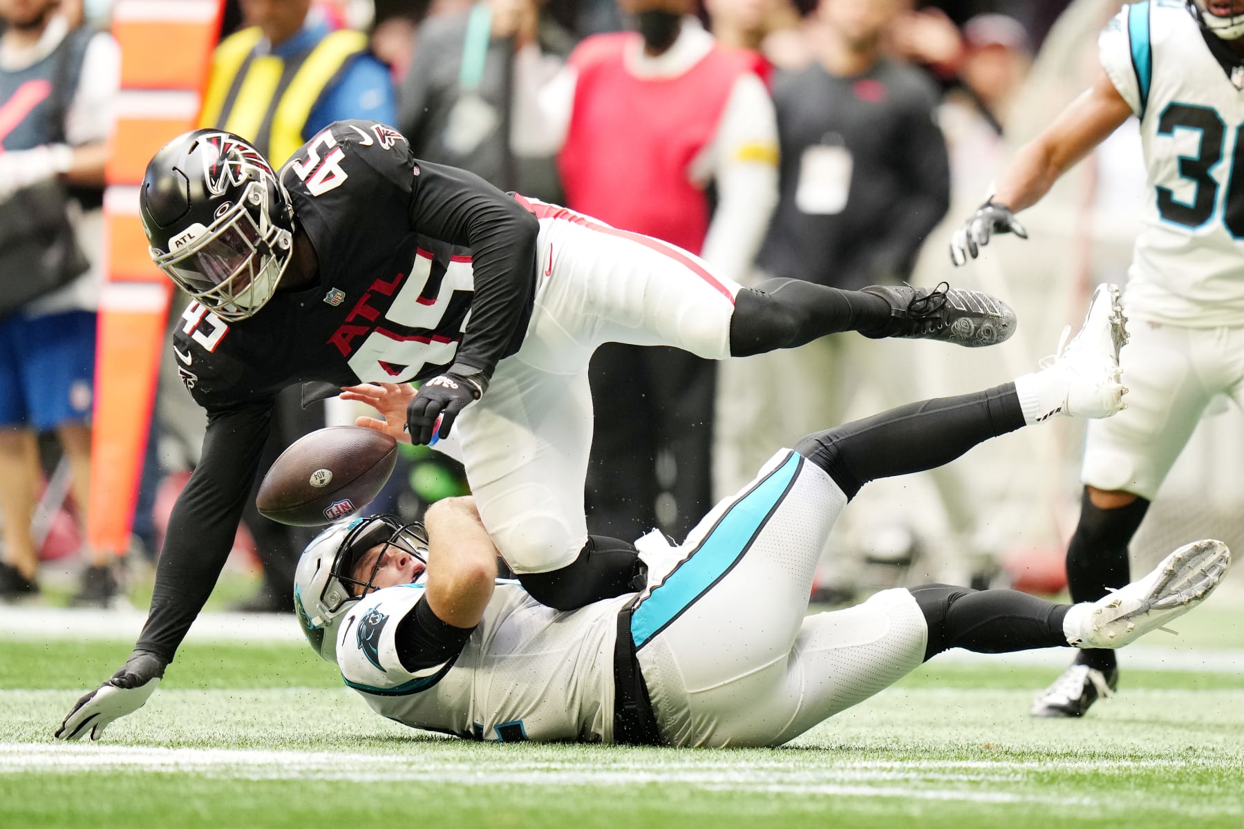 ATLANTA, GEORGIA - OCTOBER 31: Deion Jones #45 of the Atlanta Falcons tackles Sam Darnold #14 of the Carolina Panthers in the fourth quarter at Mercedes-Benz Stadium on October 31, 2021 in Atlanta, Georgia. (Photo by Mark Brown/Getty Images)
