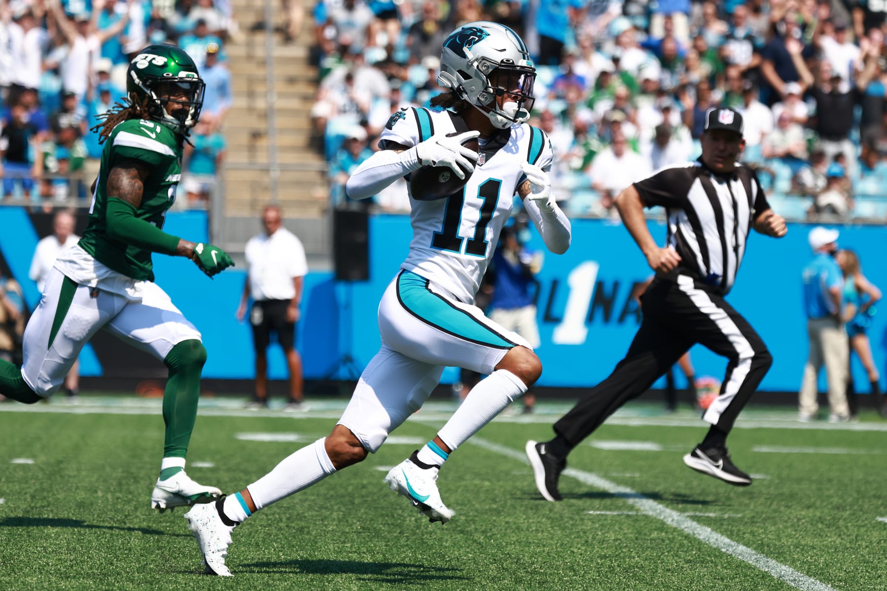 CHARLOTTE, NORTH CAROLINA - SEPTEMBER 12: Robby Anderson #11 of the Carolina Panthers catches a 57-yard pass from Sam Darnold #14 for a touchdown during the second quarter against the New York Jets at Bank of America Stadium on September 12, 2021 in Charlotte, North Carolina. (Photo by Grant Halverson/Getty Images)