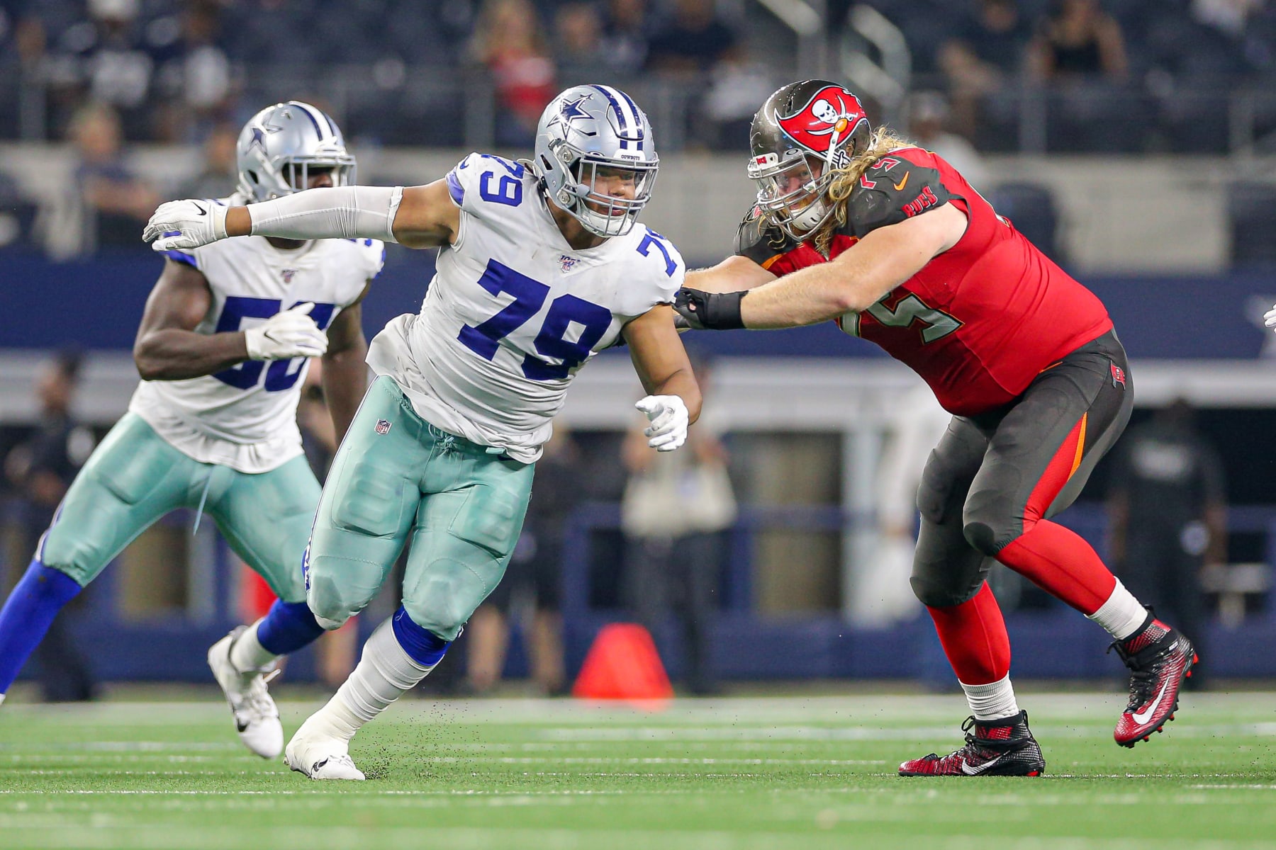 ARLINGTON, TX - AUGUST 29: Dallas Cowboys defensive tackle Trysten Hill (79) runs around the block of Tampa Bay Buccaneers offensive tackle William Poehls (75) during the preseason game between the Tampa Bay Buccaneers and Dallas Cowboys on August 29, 2019 at AT&T Stadium in Arlington, TX. (Photo by Andrew Dieb/Icon Sportswire via Getty Images)
