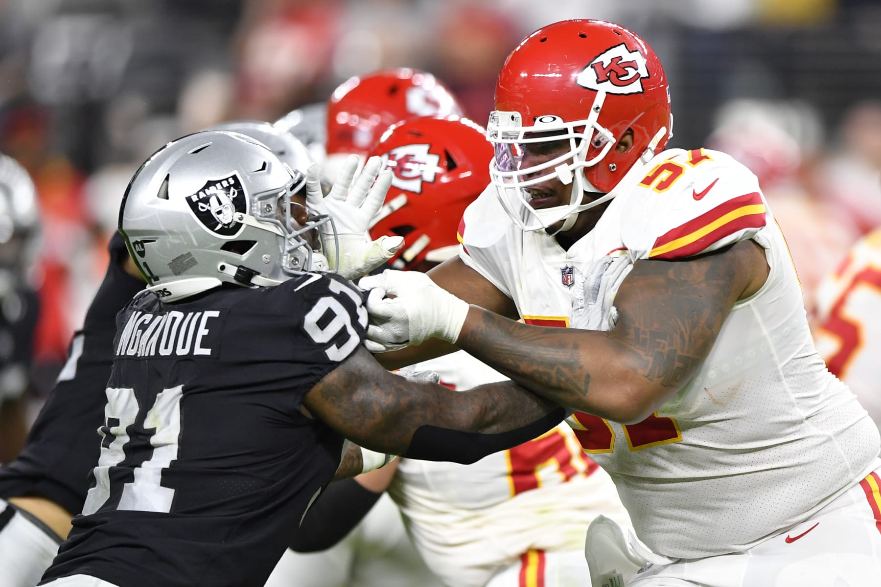 LAS VEGAS, NEVADA - NOVEMBER 14:  Offensive tackle Orlando Brown #57 of the Kansas City Chiefs blocks defensive end Yannick Ngakoue #91 of the Las Vegas Raiders during the first half of a game  at Allegiant Stadium on November 14, 2021 in Las Vegas, Nevada. The Chiefs defeated the Raiders 41-14. (Photo by Chris Unger/Getty Images)