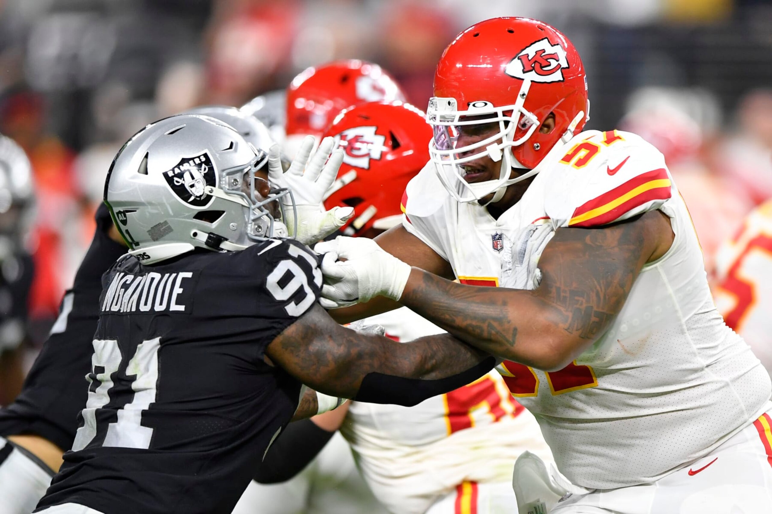 LAS VEGAS, NEVADA - NOVEMBER 14:  Offensive tackle Orlando Brown #57 of the Kansas City Chiefs blocks defensive end Yannick Ngakoue #91 of the Las Vegas Raiders during the first half of a game  at Allegiant Stadium on November 14, 2021 in Las Vegas, Nevada. The Chiefs defeated the Raiders 41-14. (Photo by Chris Unger/Getty Images)
