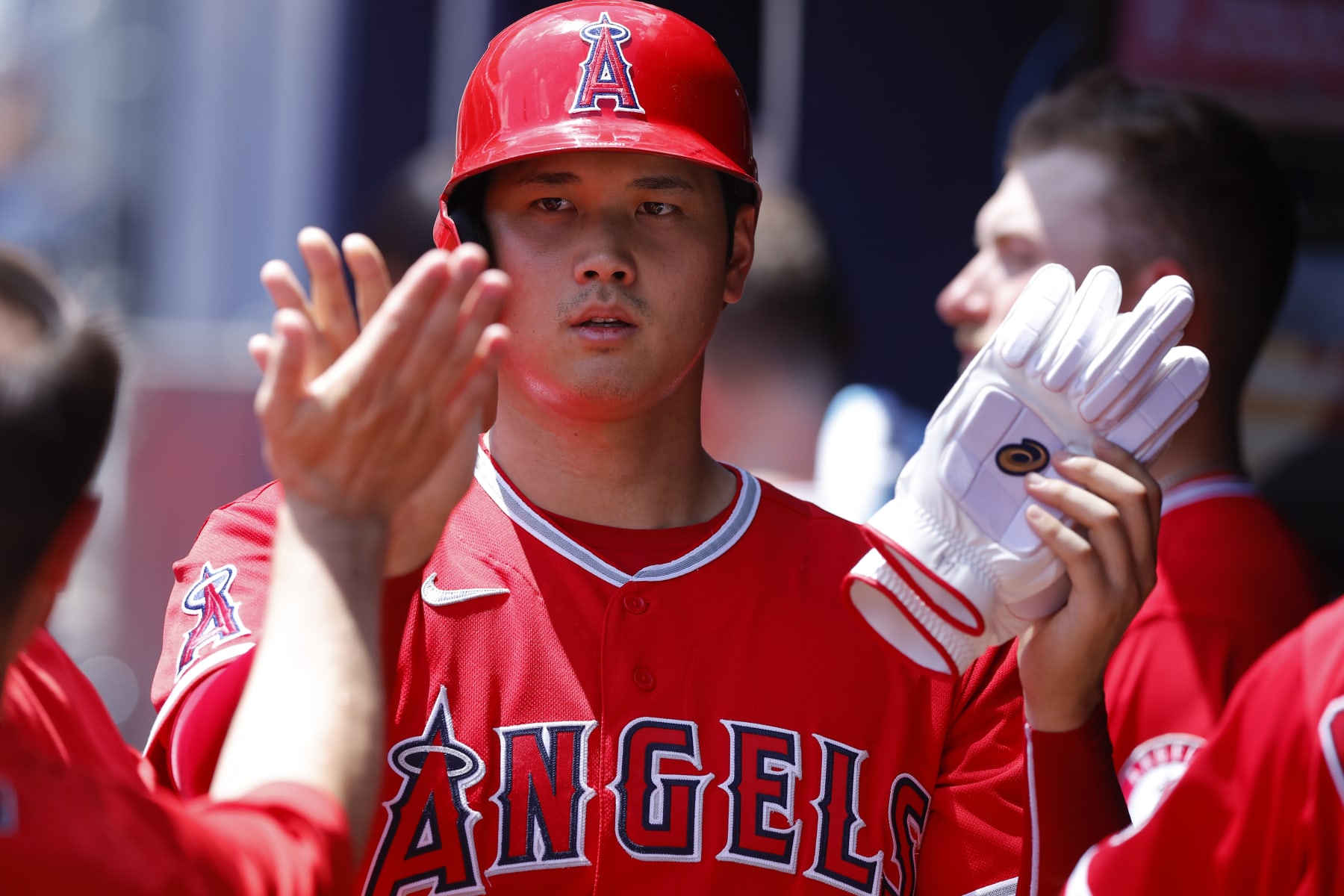 ATLANTA, GA - JULY 24: Shohei Ohtani #17 of the Los Angeles Angels reacts with teammates after scoring during the fourth inning against the Atlanta Braves at Truist Park on July 24, 2022 in Atlanta, Georgia. (Photo by Todd Kirkland/Getty Images)