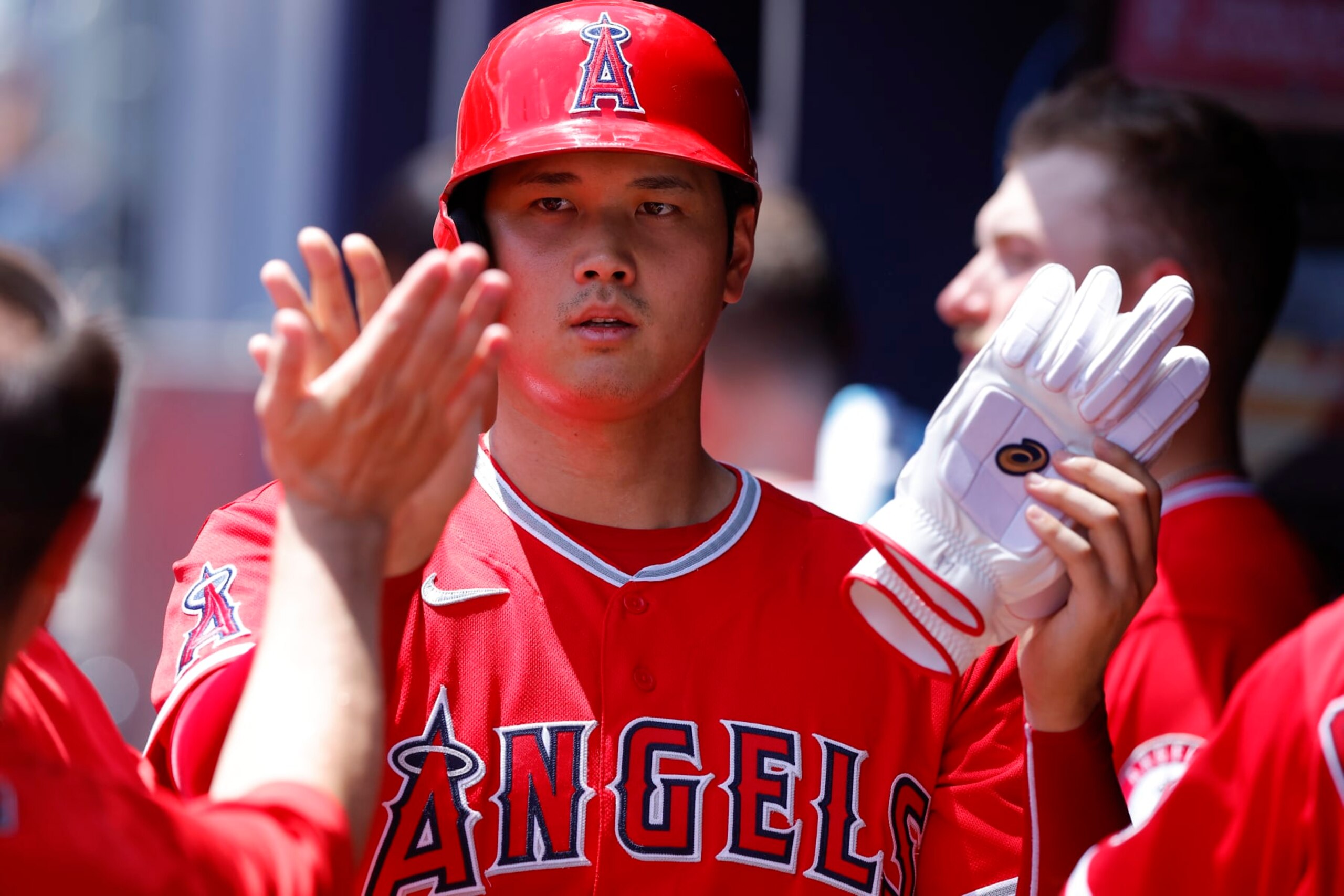 ATLANTA, GA - JULY 24: Shohei Ohtani #17 of the Los Angeles Angels reacts with teammates after scoring during the fourth inning against the Atlanta Braves at Truist Park on July 24, 2022 in Atlanta, Georgia. (Photo by Todd Kirkland/Getty Images)