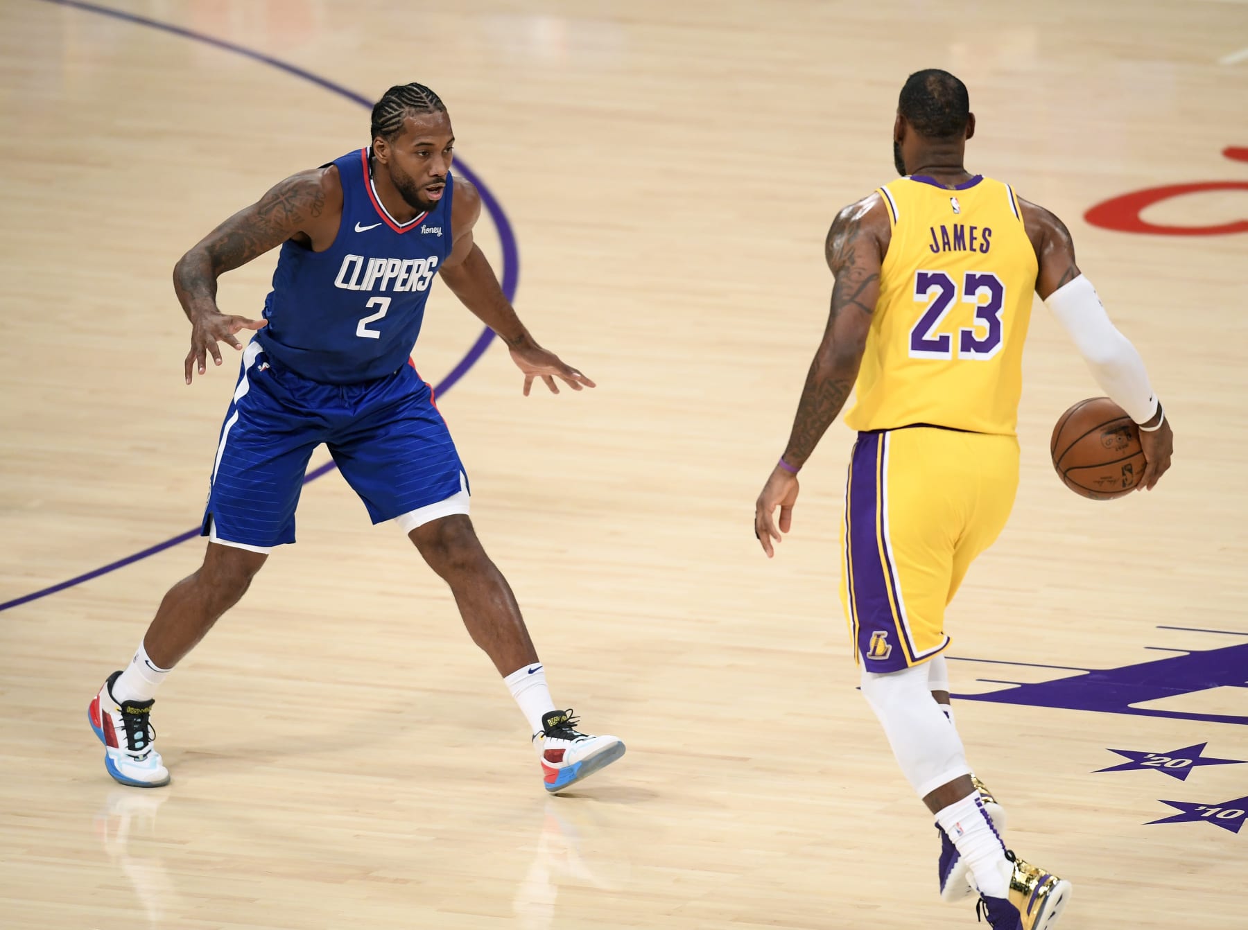 LOS ANGELES, CALIFORNIA - DECEMBER 22:  Kawhi Leonard #2 of the LA Clippers guards LeBron James #23 of the Los Angeles Lakers during the season opening game at Staples Center on December 22, 2020 in Los Angeles, California. NOTE TO USER: User expressly acknowledges and agrees that, by downloading and or using this photograph, User is consenting to the terms and conditions of the Getty Images License Agreement. (Photo by Harry How/Getty Images)