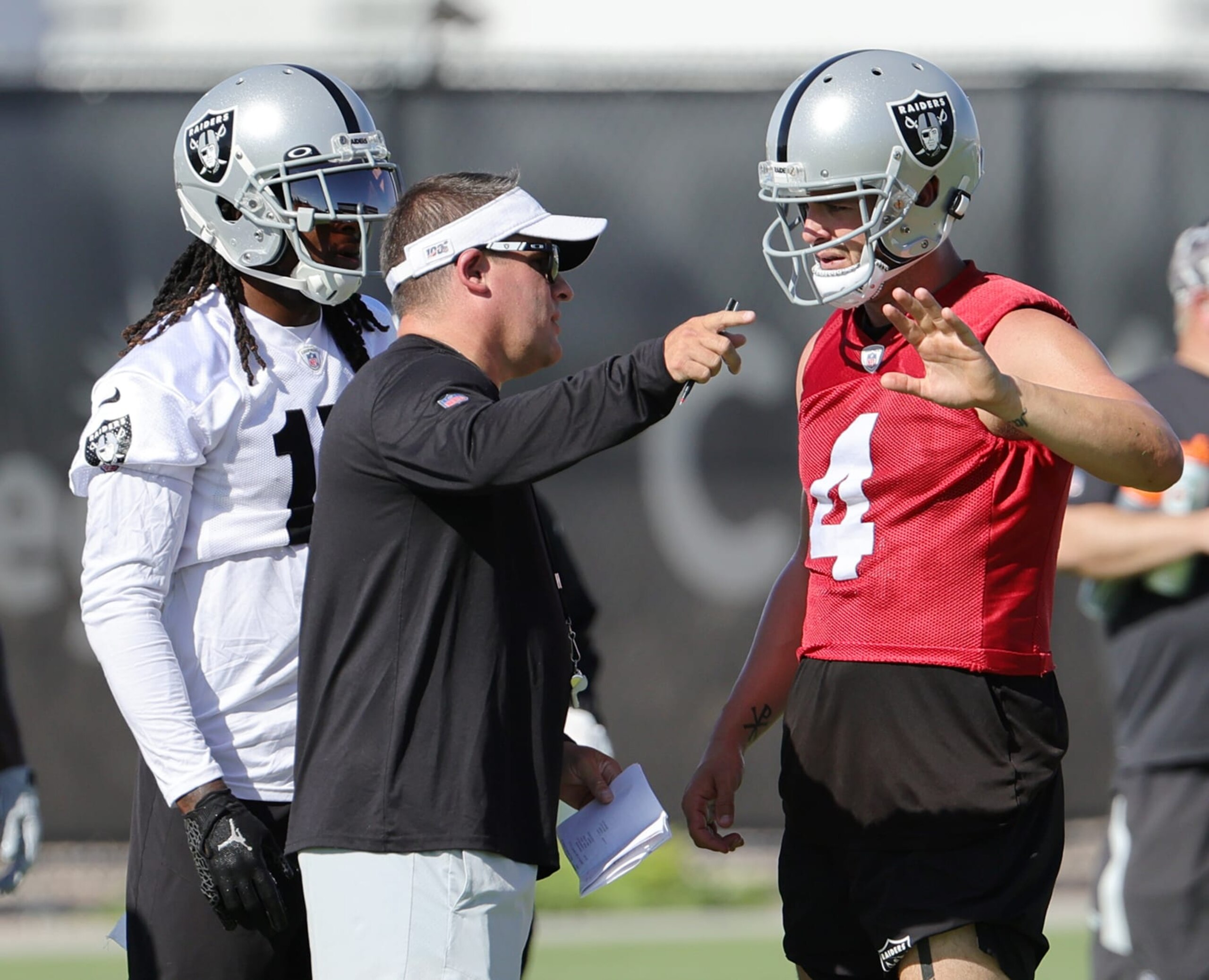 HENDERSON, NEVADA - JULY 24: Wide receiver Davante Adams #17, head coach Josh McDaniels and quarterback Derek Carr #4 of the Las Vegas Raiders talk during training camp at the Las Vegas Raiders Headquarters/Intermountain Healthcare Performance Center on July 24, 2022 in Henderson, Nevada. (Photo by Ethan Miller/Getty Images)