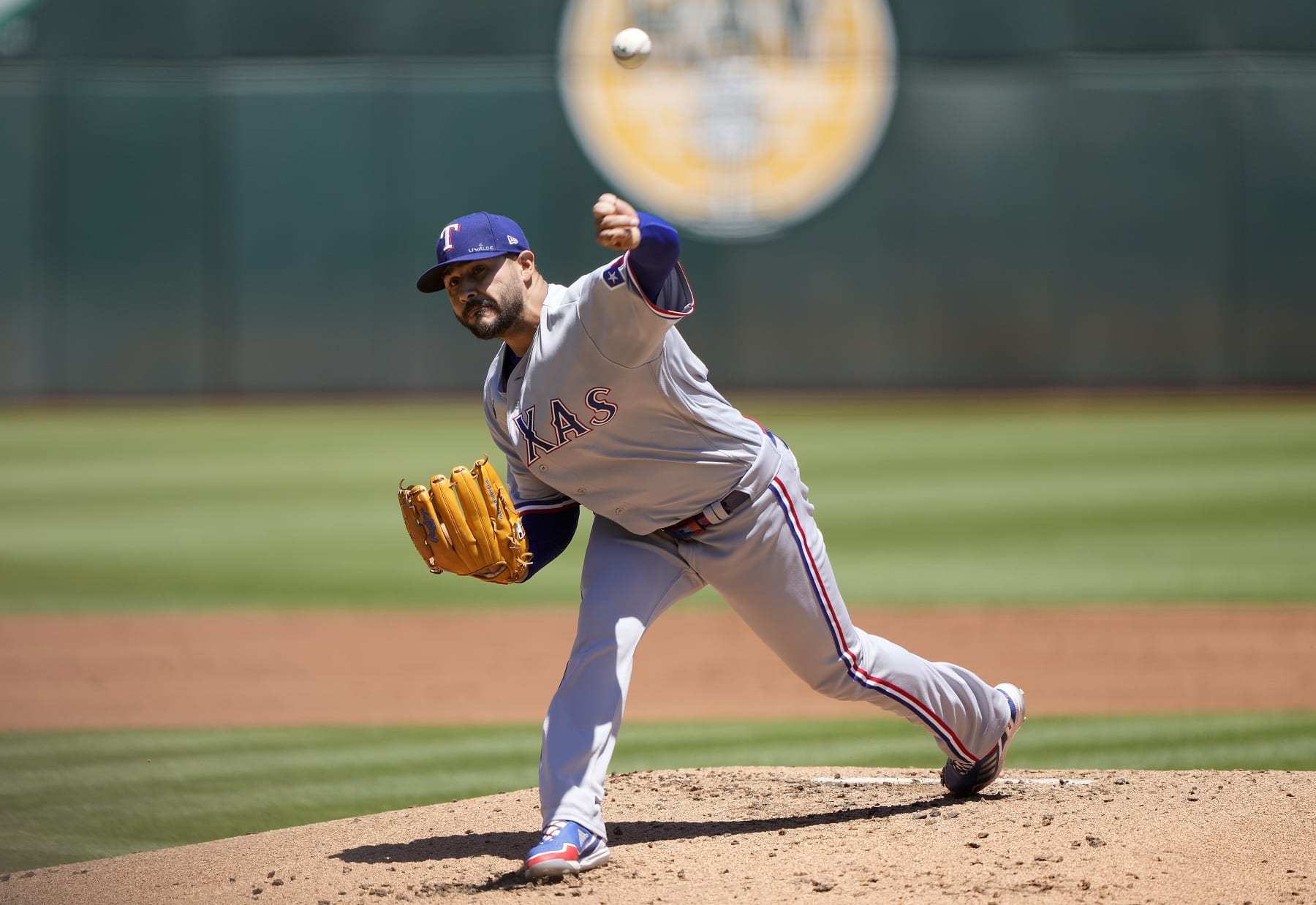 OAKLAND, CALIFORNIA - JULY 24: Martin Perez #54 of the Texas Rangers pitches against the Oakland Athletics in the bottom of the first inning at RingCentral Coliseum on July 24, 2022 in Oakland, California. (Photo by Thearon W. Henderson/Getty Images)