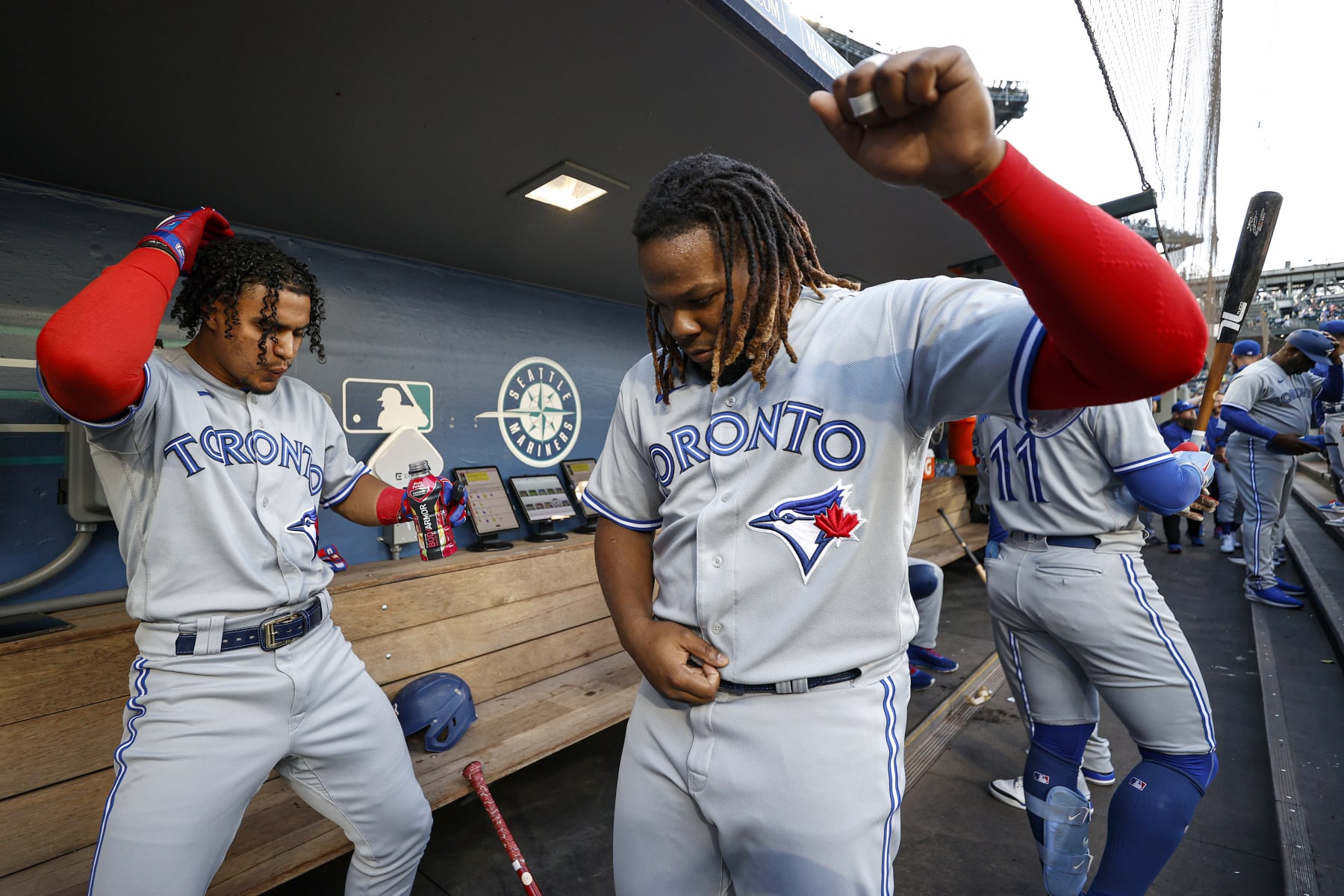 SEATTLE, WASHINGTON - JULY 07: Santiago Espinal #5 and Vladimir Guerrero Jr. #27 of the Toronto Blue Jays hype themselves up before the game against the Seattle Mariners at T-Mobile Park on July 07, 2022 in Seattle, Washington. (Photo by Steph Chambers/Getty Images)