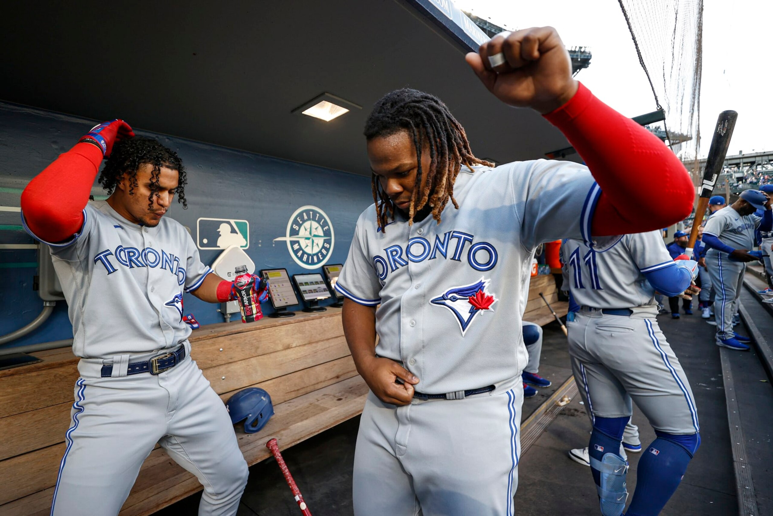 SEATTLE, WASHINGTON - JULY 07: Santiago Espinal #5 and Vladimir Guerrero Jr. #27 of the Toronto Blue Jays hype themselves up before the game against the Seattle Mariners at T-Mobile Park on July 07, 2022 in Seattle, Washington. (Photo by Steph Chambers/Getty Images)