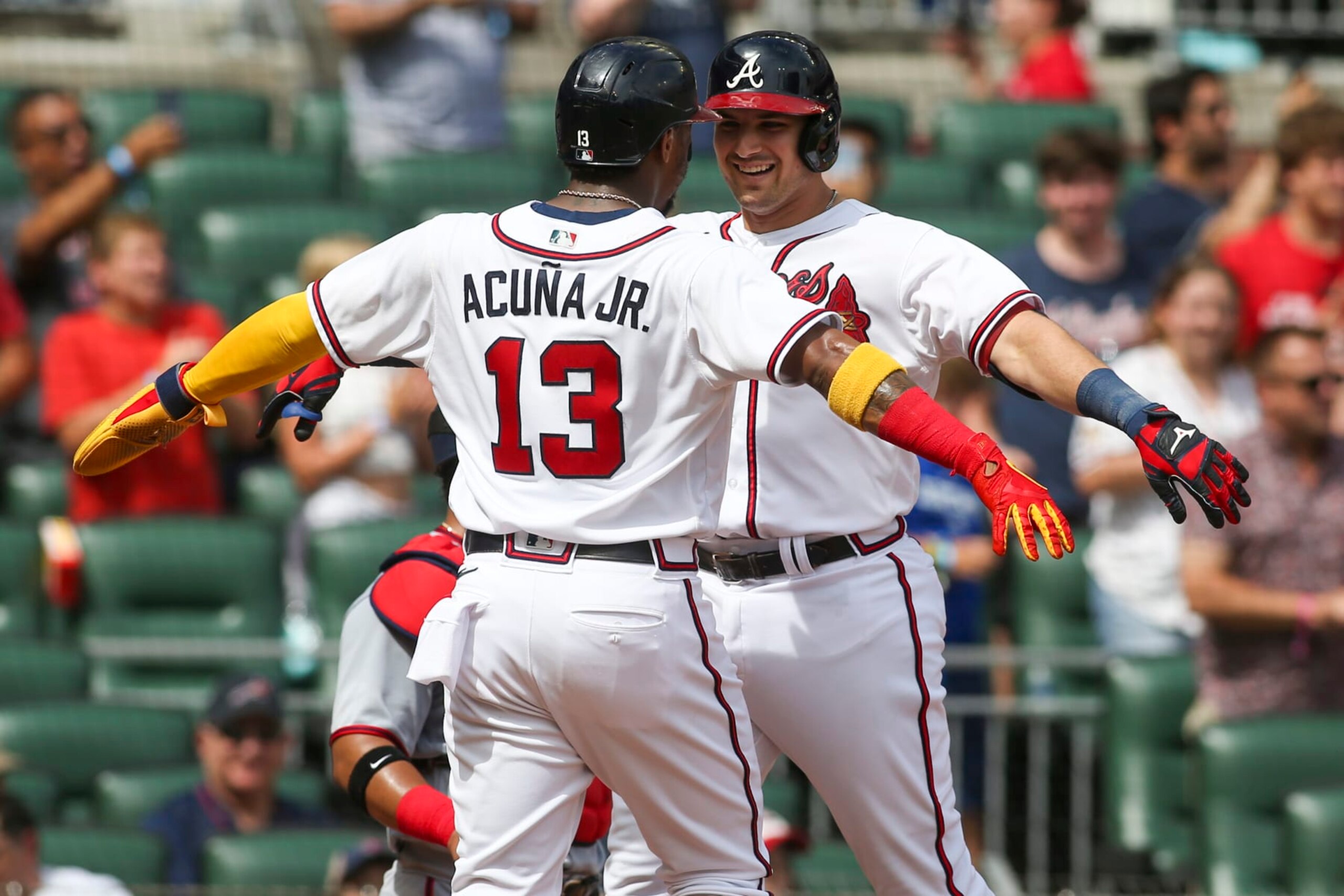 ATLANTA, GA - JULY 09: Austin Riley #27 celebrates with Ronald Acuna Jr. #13 of the Atlanta Braves after a two-run home run against the Washington Nationals in the first inning at Truist Park on July 9, 2022 in Atlanta, Georgia. (Photo by Brett Davis/Getty Images)