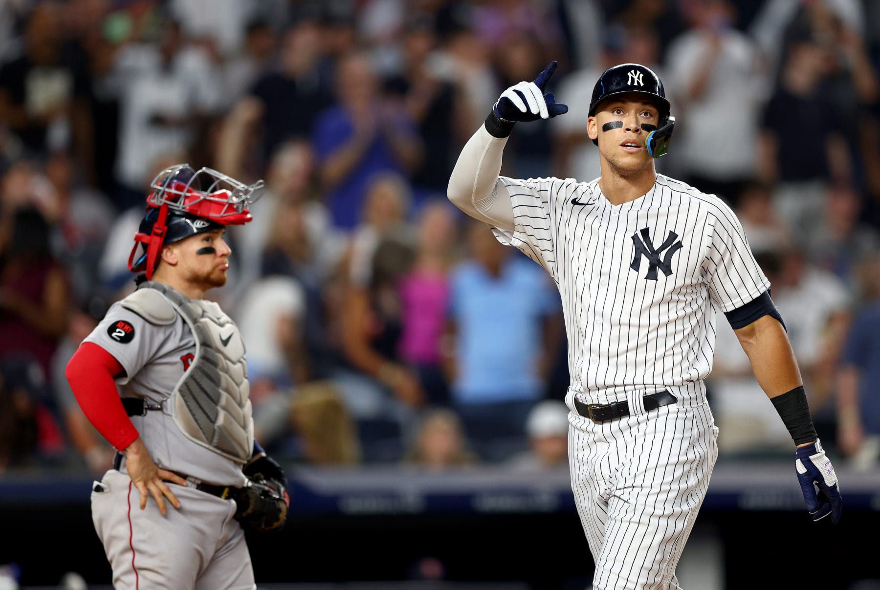 NEW YORK, NEW YORK - JULY 16:  Aaron Judge #99 of the New York Yankees celebrates his solo home run as Christian Vazquez #7 of the Boston Red Sox reacts in the fifth inning at Yankee Stadium on July 16, 2022 in the Bronx borough of New York City. (Photo by Elsa/Getty Images)