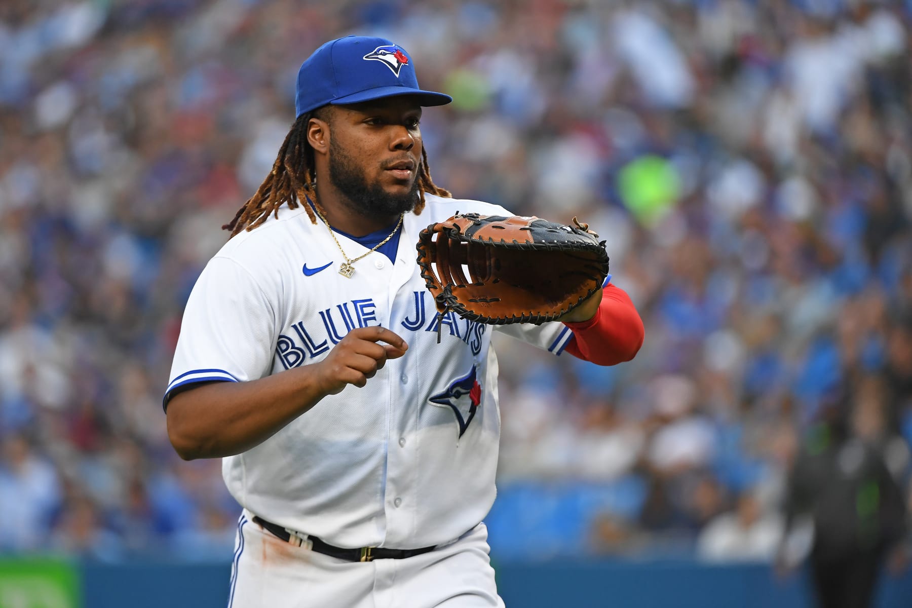 TORONTO, ON - JULY 14: Toronto Blue Jays First Base Vladimir Guerrero Jr. (27) heads to the dugout between innings during the regular season MLB game between the Kansas City Royals and Toronto Blue Jays on July 14, 2022 at Rogers Centre in Toronto, ON. (Photo by Gerry Angus/Icon Sportswire via Getty Images)