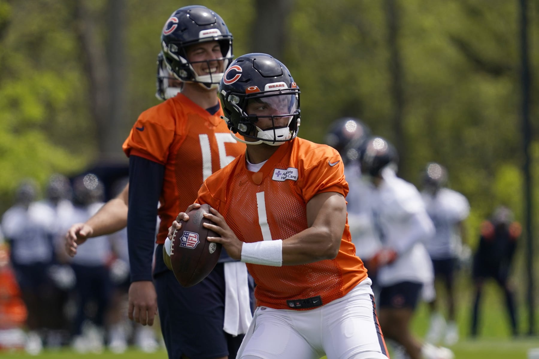 Chicago Bears quarterback Justin Fields throws a pass at the NFL football team's practice facility in Lake Forest, Ill., Wednesday, May 17, 2022. (AP Photo/Nam Y. Huh)
