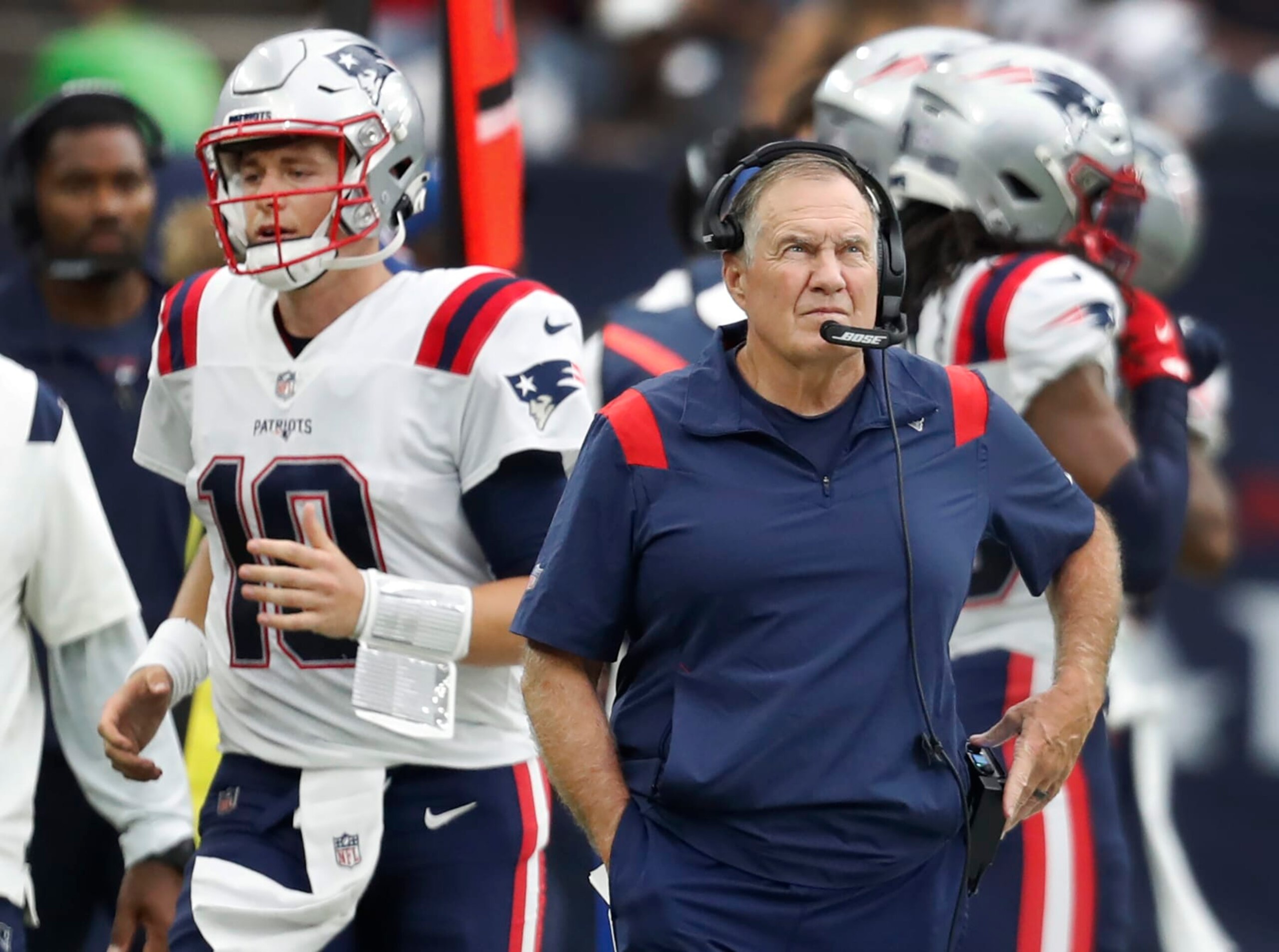 Houston, MA - October  10: Patriots quarterback Mac Jones (10) is pictured walking past head coach Bill Belichick after throwing an interception very early in the third quarter. The New England Patriots visited the Houston Texans for a regular season NFL football game at NRG Stadium in Houston, TX on Oct. 10, 2021. (Photo by Jim Davis/The Boston Globe via Getty Images)