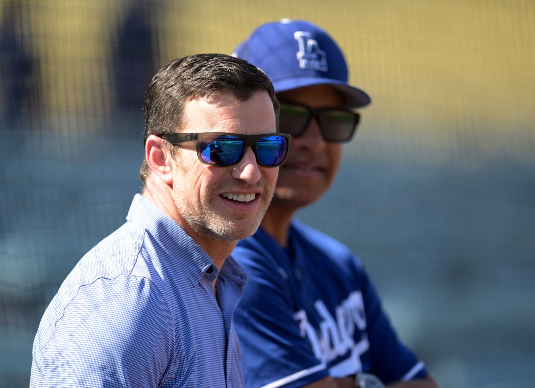 LOS ANGELES, CA - APRIL 05: Andrew Friedman, President of Baseball Operations and manager Dave Roberts #30 of the Los Angeles Dodgers talk on the field before a preseason game against the Los Angeles Angels at Dodger Stadium on April 5, 2022 in Los Angeles, California. (Photo by Jayne Kamin-Oncea/Getty Images)