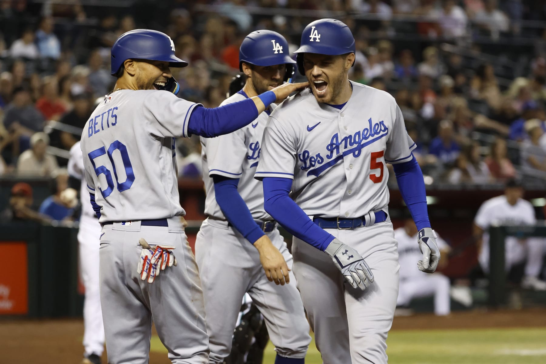 PHOENIX, ARIZONA - MAY 26: Freddie Freeman #5 of the Los Angeles Dodgers reacts with teammate Mookie Betts #50 after Freeman's three-run home run during the second inning against the Arizona Diamondbacks at Chase Field on May 26, 2022 in Phoenix, Arizona. (Photo by Chris Coduto/Getty Images)