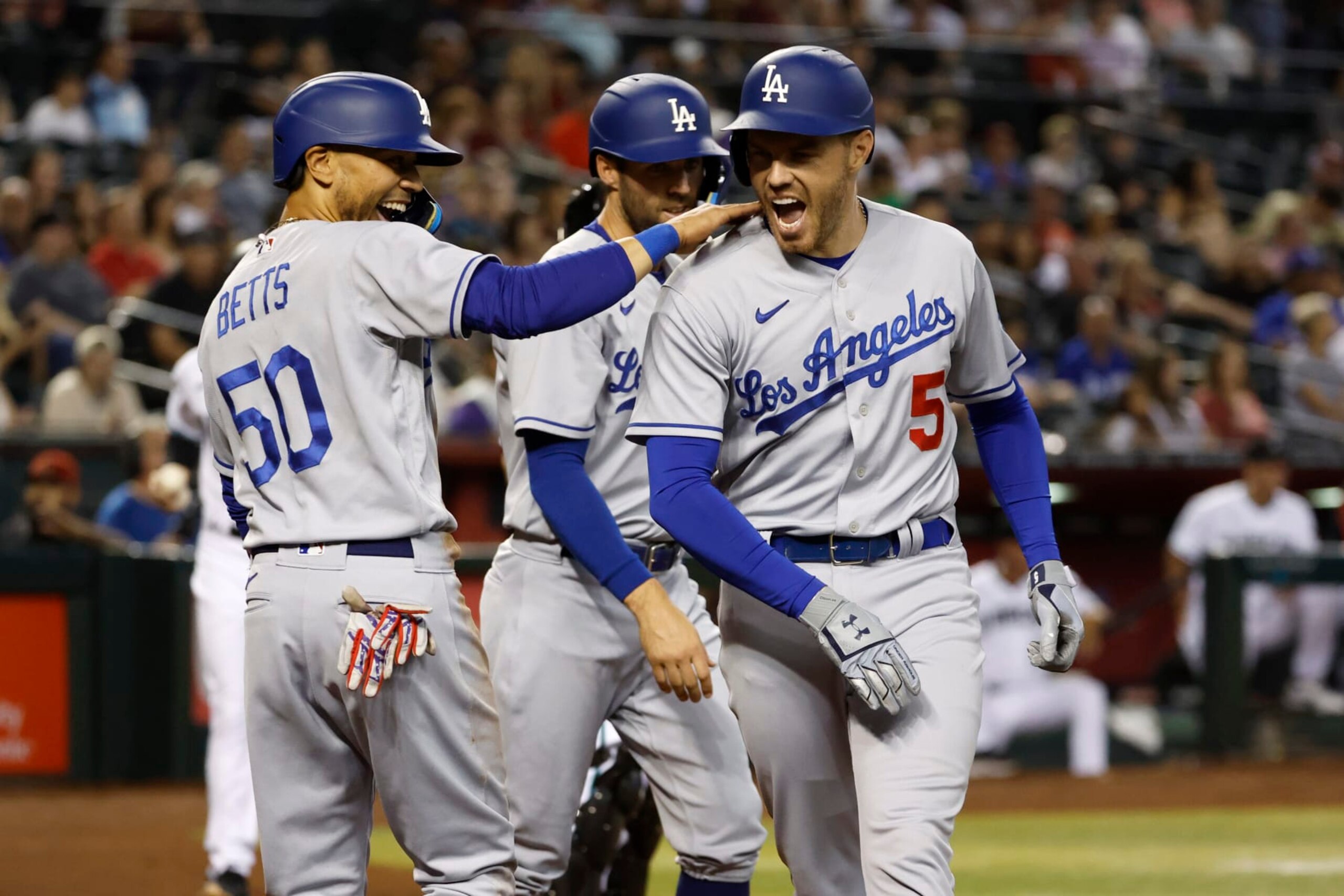 PHOENIX, ARIZONA - MAY 26: Freddie Freeman #5 of the Los Angeles Dodgers reacts with teammate Mookie Betts #50 after Freeman's three-run home run during the second inning against the Arizona Diamondbacks at Chase Field on May 26, 2022 in Phoenix, Arizona. (Photo by Chris Coduto/Getty Images) PHOENIX, ARIZONA - MAY 26: Freddie Freeman #5 of the Los Angeles Dodgers reacts with teammate Mookie Betts #50 after Freeman's three-run home run during the second inning against the Arizona Diamondbacks at Chase Field on May 26, 2022 in Phoenix, Arizona. (Photo by Chris Coduto/Getty Images)