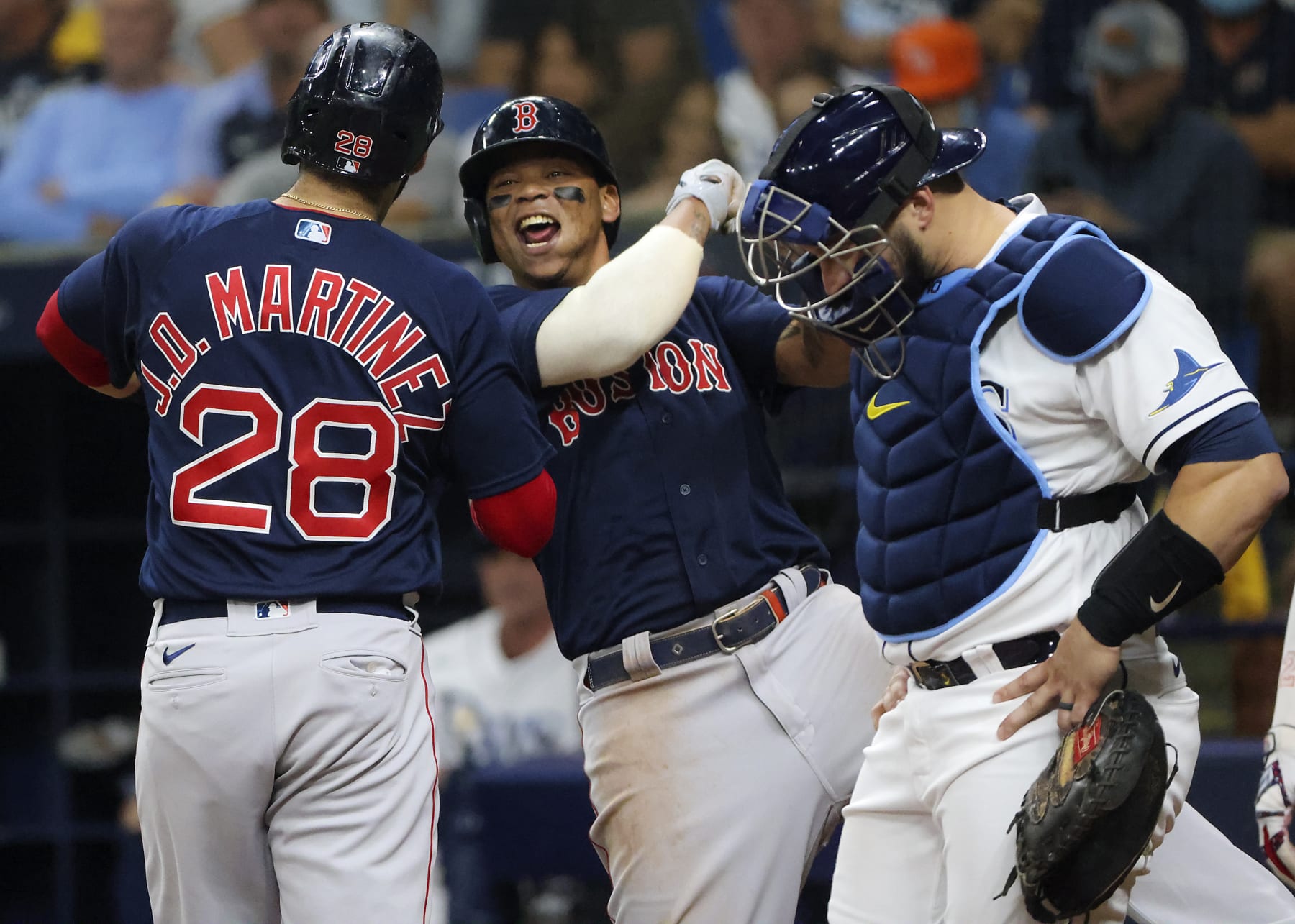 St. Petersburg - October 8: Boston Red Sox left fielder J.D. Martinez (28) at home plate celebrating with teammate Rafael Devers after hitting a go ahead 3 run home run in front of Tampa Bay Rays catcher Mike Zunino (10) during fifth inning action. The Boston Red Sox visit the Tampa Bay Rays for Game 2 of the MLB American League Division Series (ALDS) playoff at Tropicana Field in St. Petersburg, FL on Oct. 8, 2021. (Photo by Matthew J. Lee/The Boston Globe via Getty Images) St. Petersburg - October 8: Boston Red Sox left fielder J.D. Martinez (28) at home plate celebrating with teammate Rafael Devers after hitting a go ahead 3 run home run in front of Tampa Bay Rays catcher Mike Zunino (10) during fifth inning action. The Boston Red Sox visit the Tampa Bay Rays for Game 2 of the MLB American League Division Series (ALDS) playoff at Tropicana Field in St. Petersburg, FL on Oct. 8, 2021. (Photo by Matthew J. Lee/The Boston Globe via Getty Images)