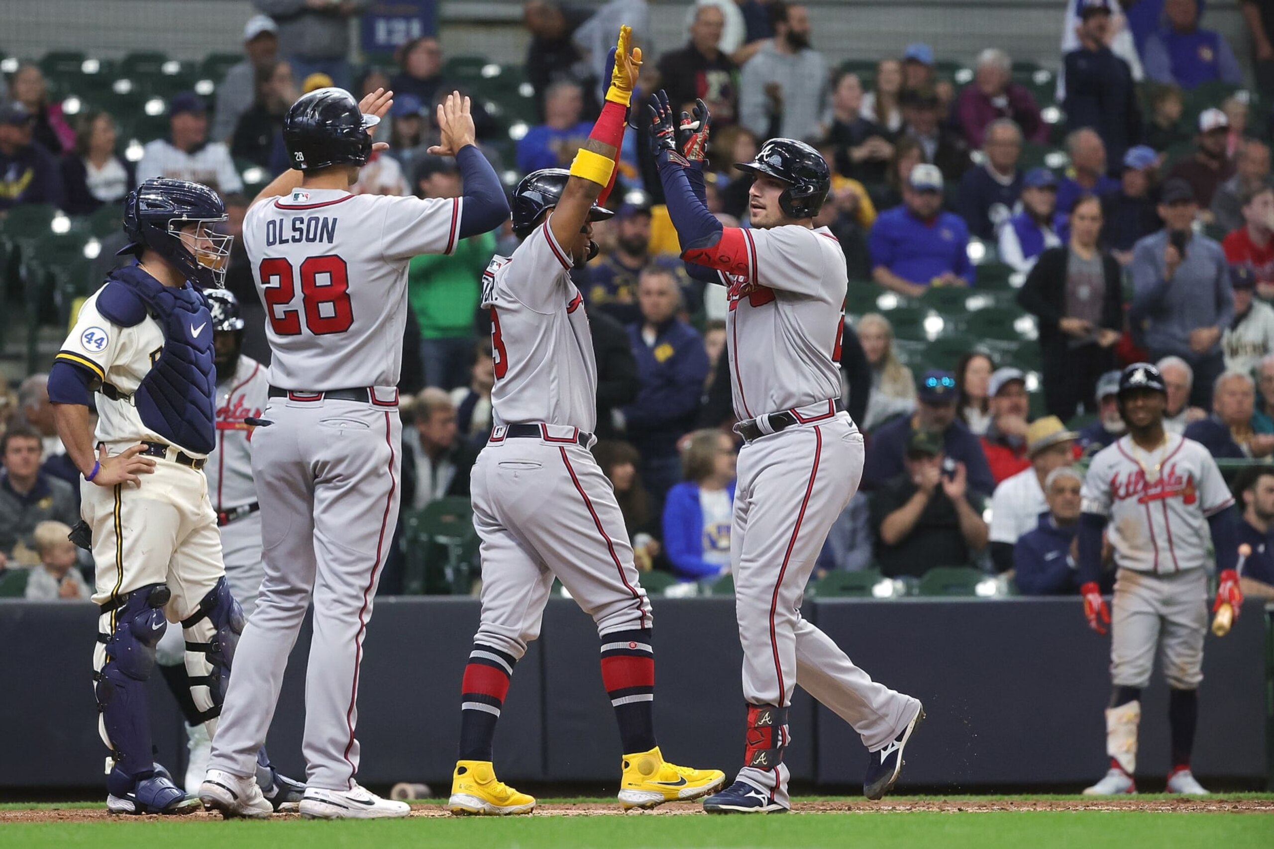 MILWAUKEE, WISCONSIN - MAY 18: Austin Riley #27 of the Atlanta Braves is congratulated by Ronald Acuna Jr. #13 and Matt Olson #28 following a three run home run against the Milwaukee Brewers at American Family Field on May 18, 2022 in Milwaukee, Wisconsin. (Photo by Stacy Revere/Getty Images)