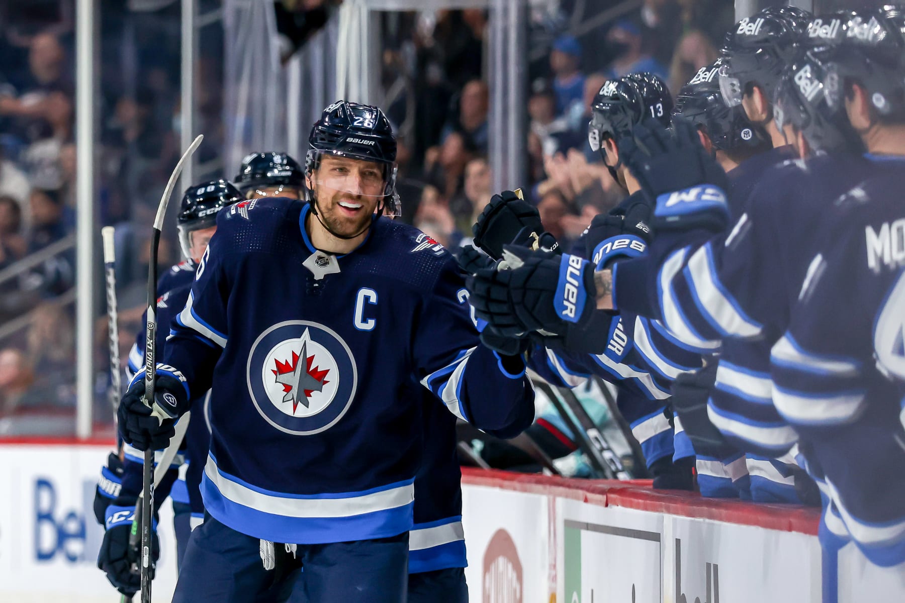WINNIPEG, MB - MAY 1: Blake Wheeler #26 of the Winnipeg Jets celebrates his third period goal against the Seattle Kraken with teammates at the bench at the Canada Life Centre on May 1, 2022 in Winnipeg, Manitoba, Canada. (Photo by Jonathan Kozub/NHLI via Getty Images)