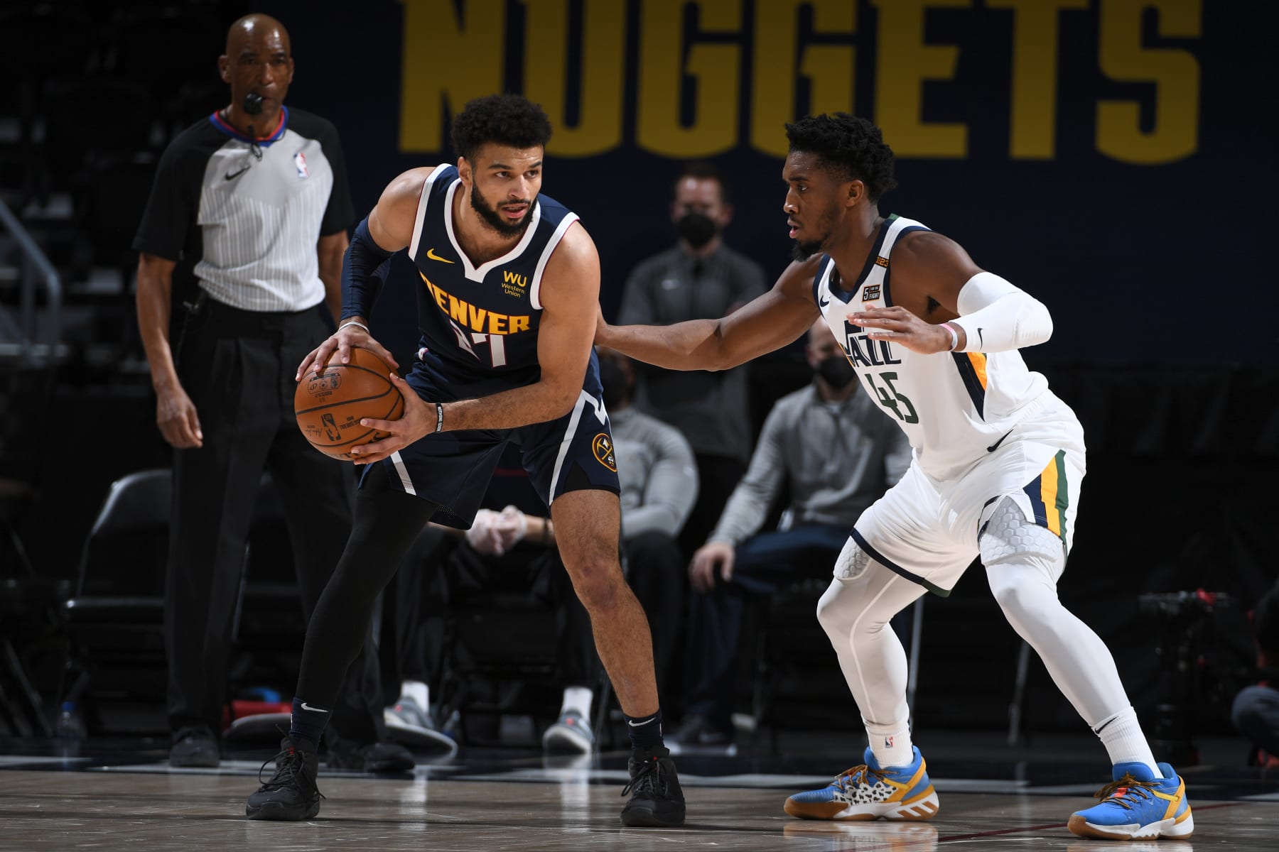 DENVER, CO - JANUARY 17: Jamal Murray #27 of the Denver Nuggets looks to pass the ball while Donovan Mitchell #45 of the Utah Jazz plays defense during the game on January 17, 2021 at the Ball Arena in Denver, Colorado. NOTE TO USER: User expressly acknowledges and agrees that, by downloading and/or using this Photograph, user is consenting to the terms and conditions of the Getty Images License Agreement. Mandatory Copyright Notice: Copyright 2021 NBAE (Photo by Garrett Ellwood/NBAE via Getty Images)