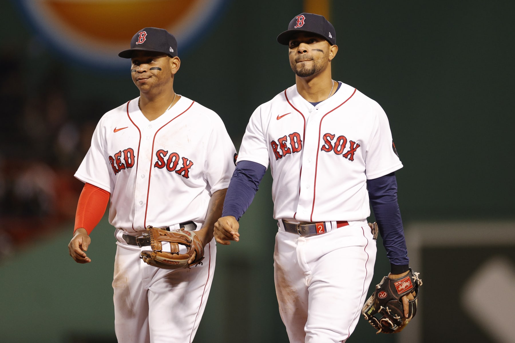 BOSTON, MASSACHUSETTS - JUNE 18: Rafael Devers #11 and Xander Bogaerts #2 of the Boston Red Sox react during the ninth inning against the St. Louis Cardinals at Fenway Park on June 18, 2022 in Boston, Massachusetts. The Cardinals won 11-2. (Photo by Sarah Stier/Getty Images)