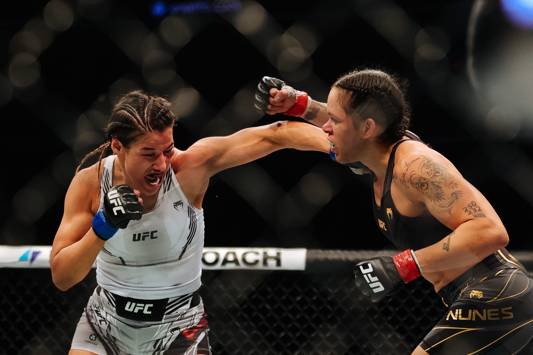 LAS VEGAS, NEVADA - DECEMBER 11: Julianna Pena (L) punches Amanda Nunes of Brazil in their women's bantamweight title fight during the UFC 269 event at T-Mobile Arena on December 11, 2021 in Las Vegas, Nevada.  (Photo by Carmen Mandato/Getty Images)