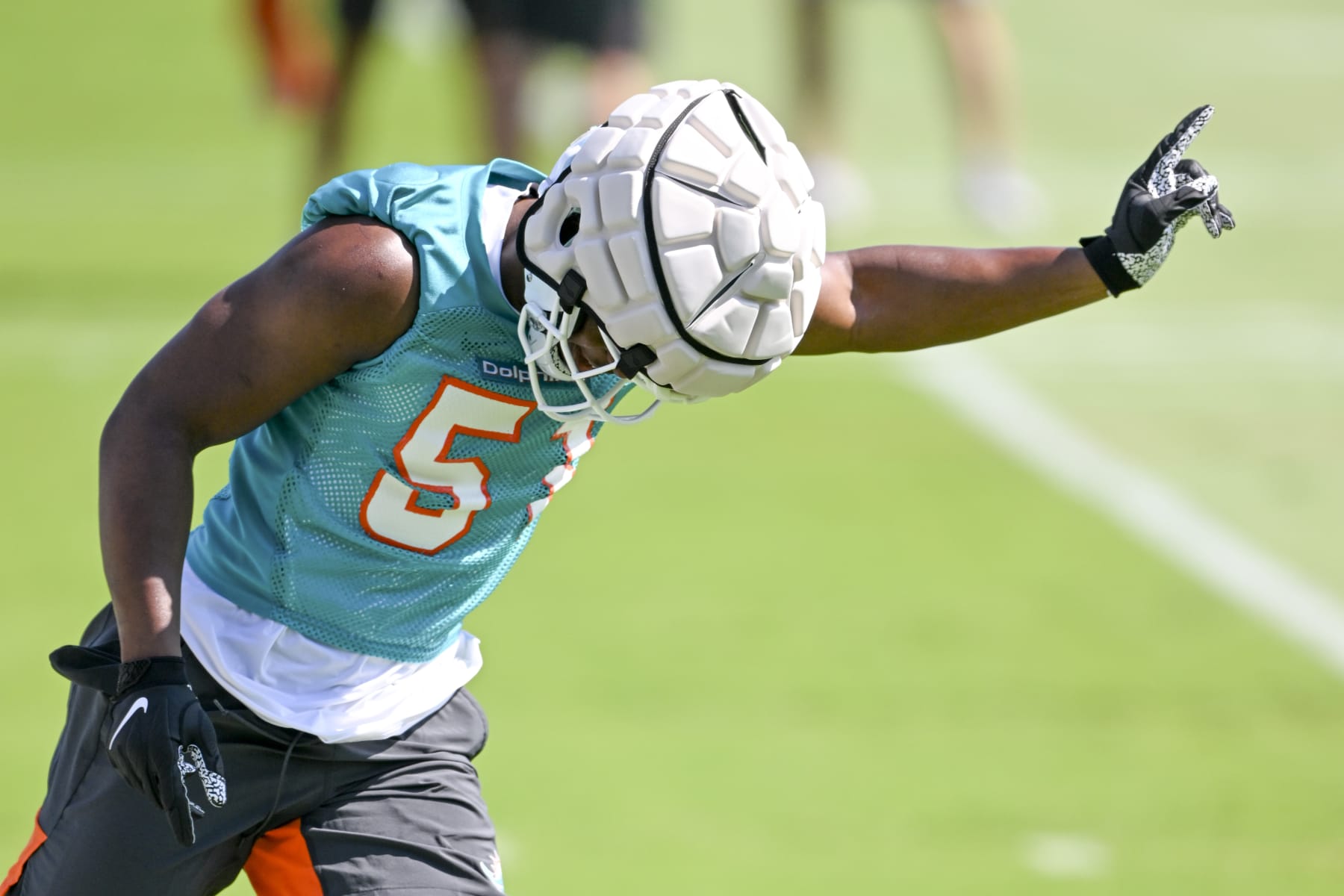 MIAMI GARDENS, FL - MAY 14: Miami Dolphins linebacker Channing Tindall (51) gestures as he runs a drill during the rookie minicamp at the Baptist Health Training Complex on May 14, 2022, in Miami Gardens, Florida. (Photo by Doug Murray/Icon Sportswire via Getty Images)